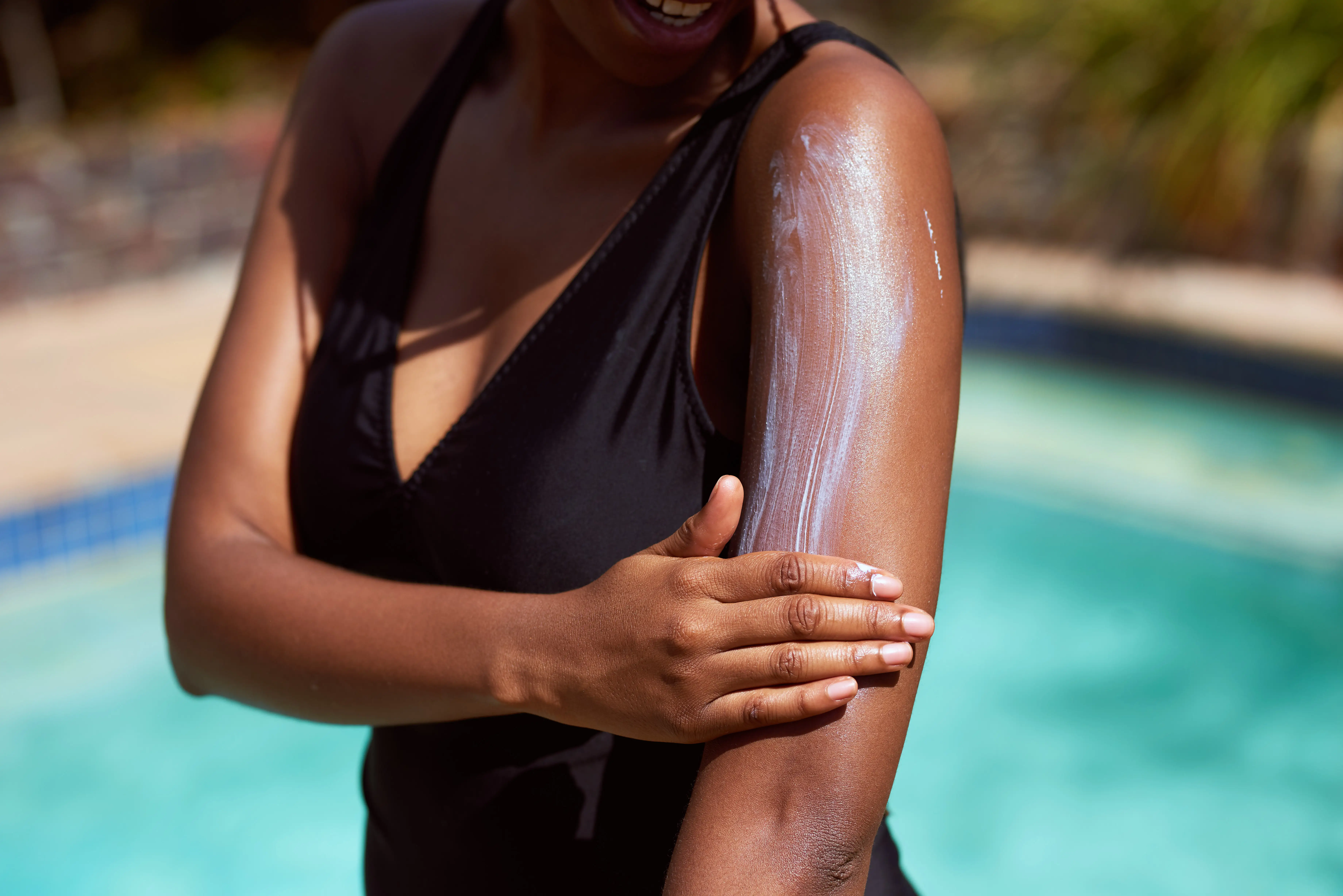 Woman applying sunscreen