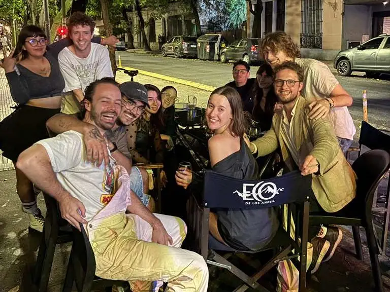A group of people dining on a street in Buenos Aires.