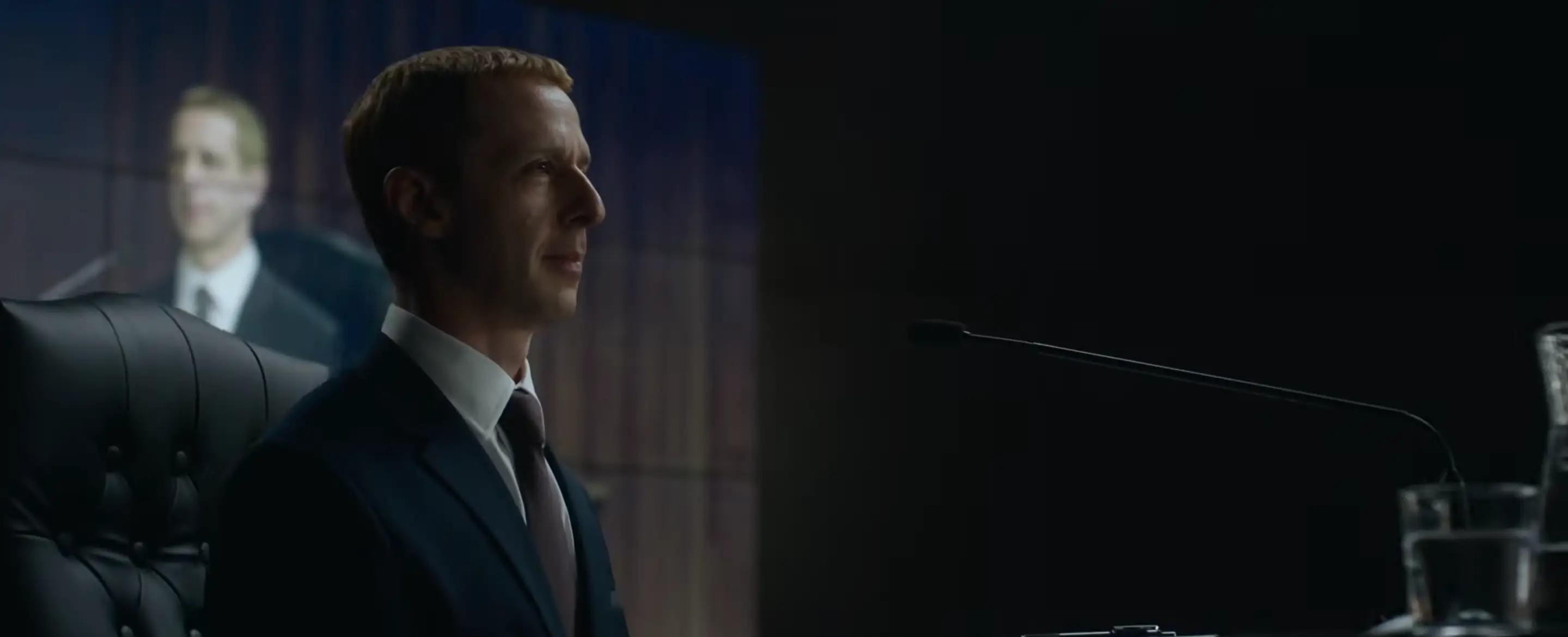 Jeremy Strong sitting in front of a microphone in The Socal Reckoning movie