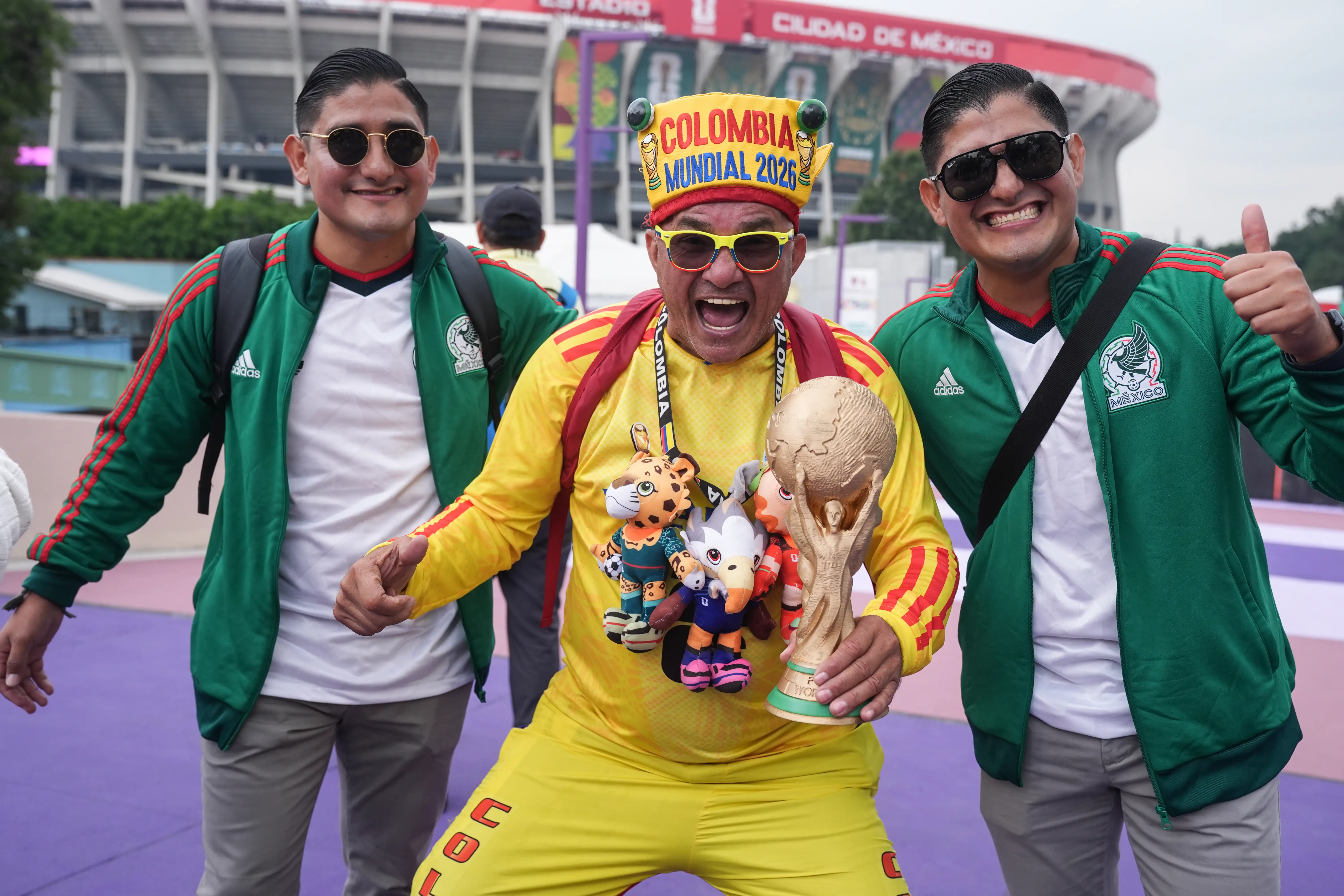 World Cup team fans stand outside a stadium.