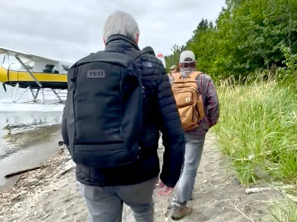 A man walking along the beach at Katmai National Park in Alaska.
