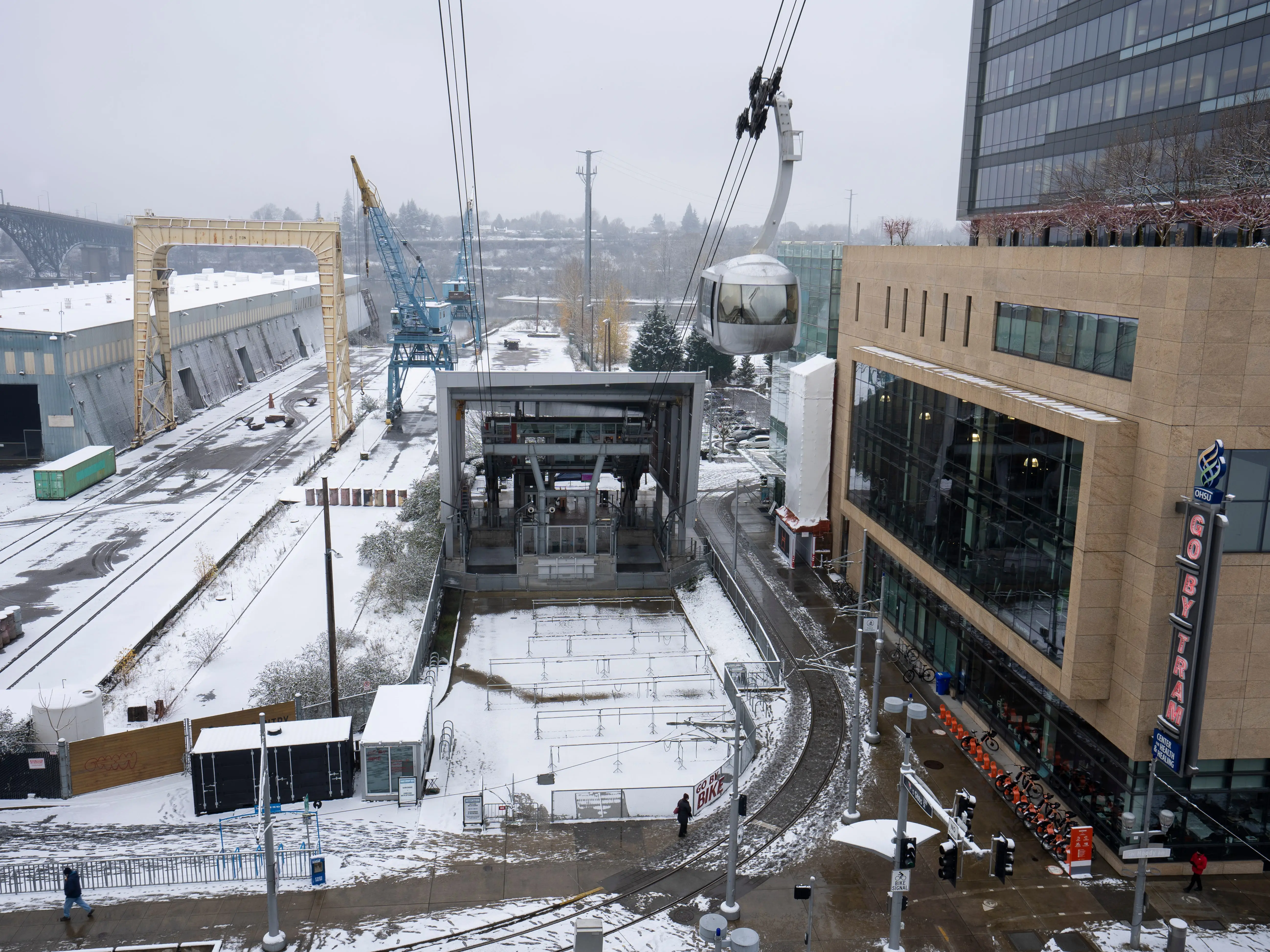 Portland, OR, USA - Dec 28, 2021: A Portland Aerial Tram car leaves the Lower Terminal at the OHSU South Waterfront campus in southwest Portland, Oregon, on a cold winter day after snowfall.