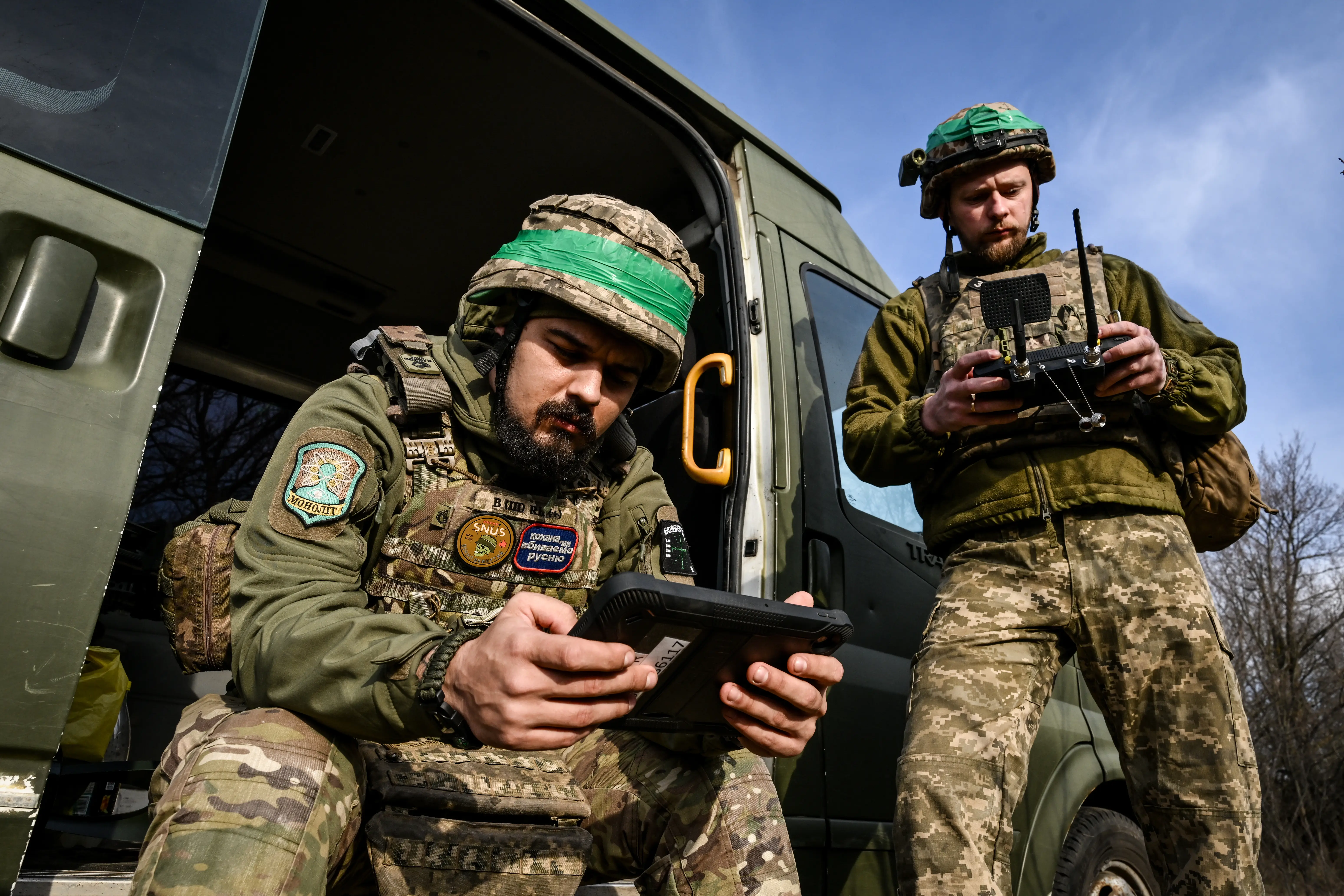 Soldiers from a drone unit of Ukraine's 422nd Separate Unmanned Systems Regiment ''Luftwaffe'' operate drones from a tablet and a remote controller.