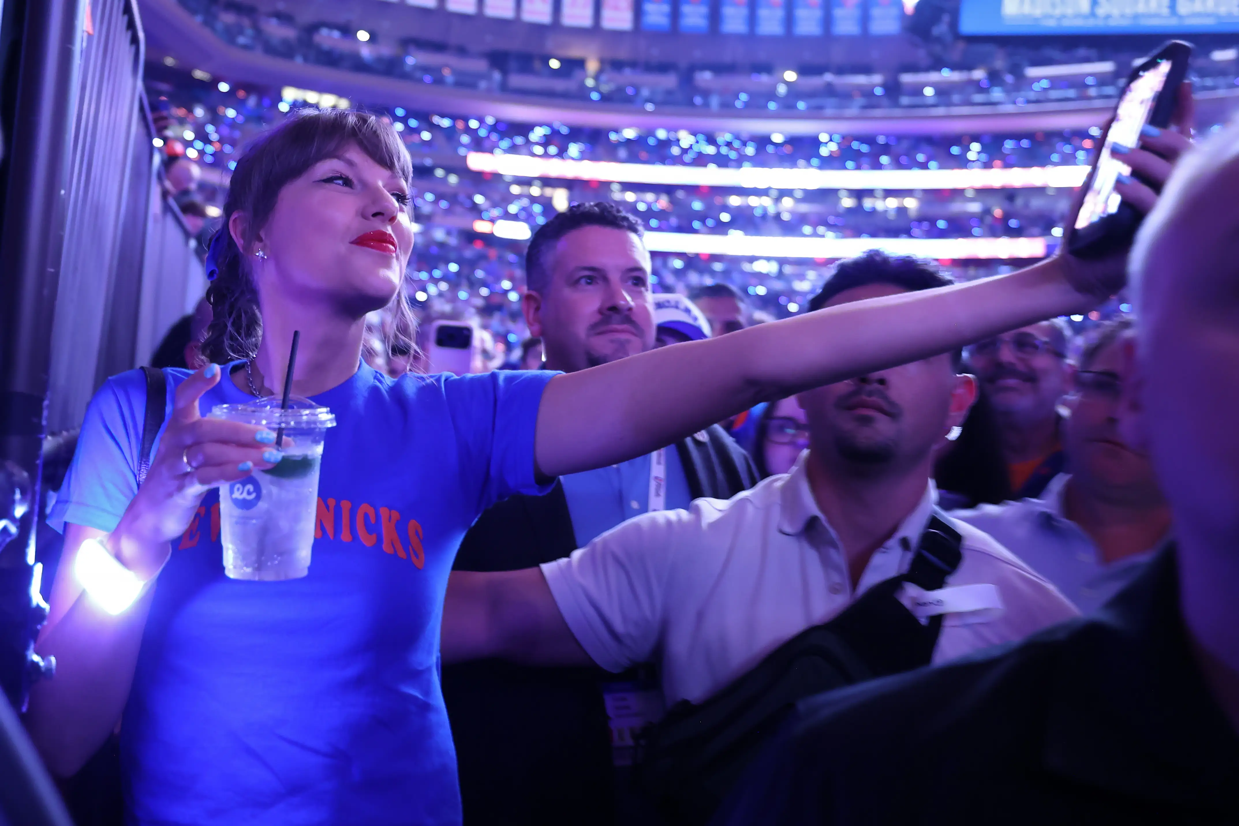 Taylor Swift taking selfie holding onto a drink at Madison Square Garden
