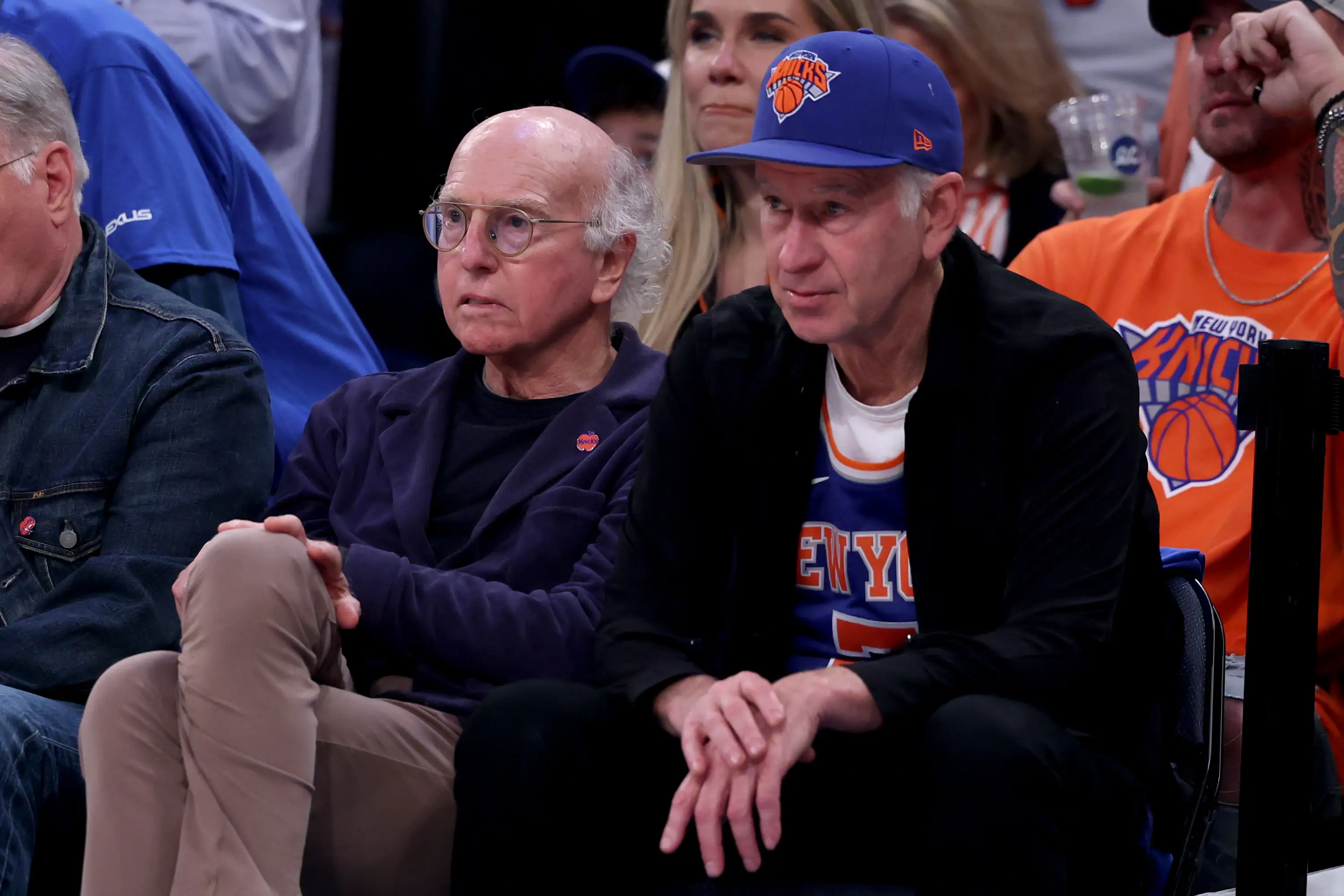 Larry David and John McEnroe sitting courtside