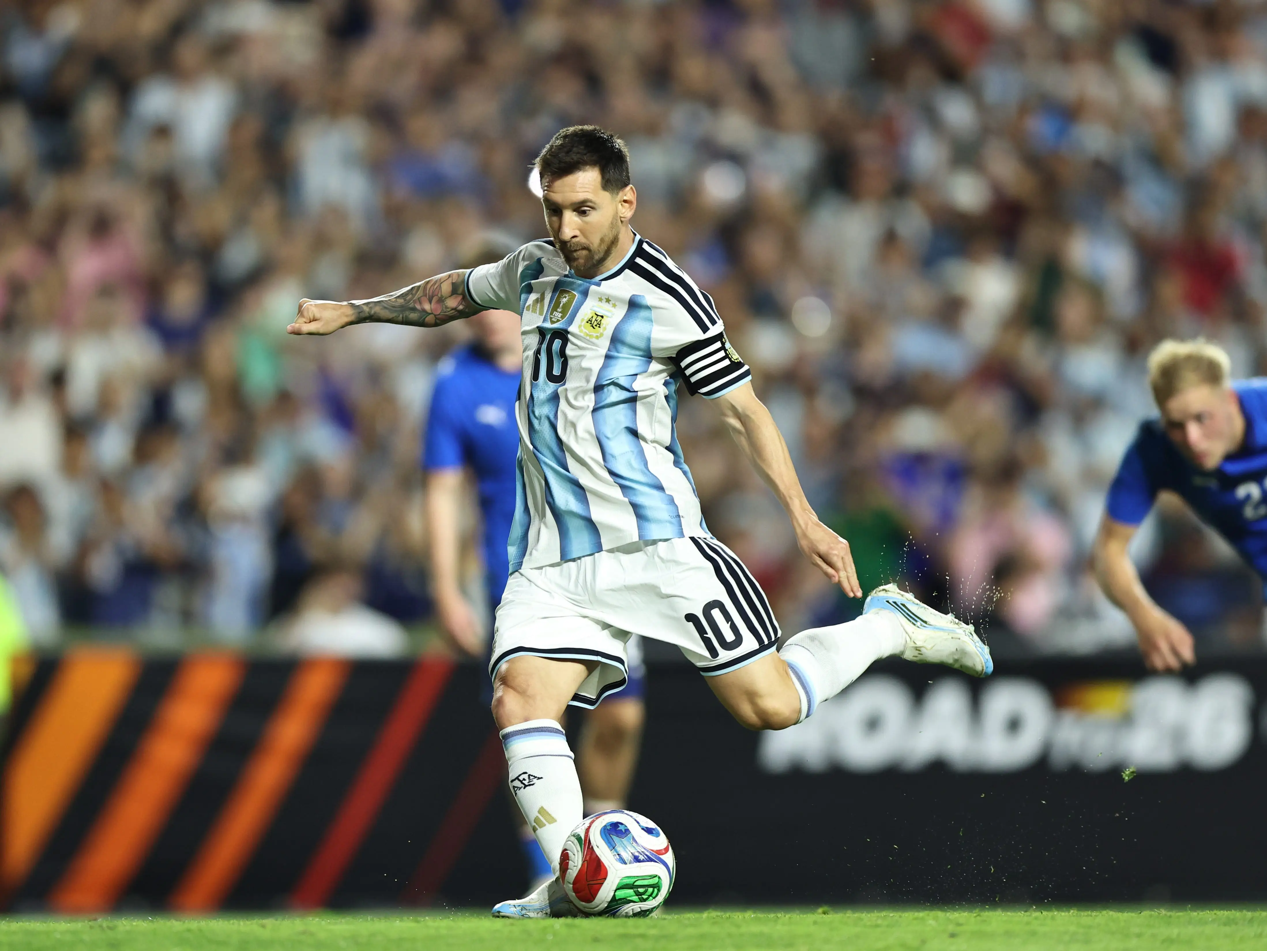 Lionel Messi in Argentina uniform kicking a soccer ball