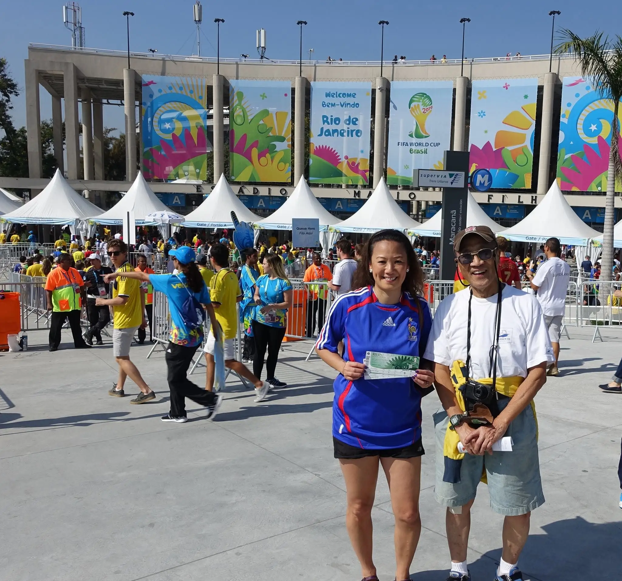 May Lee is holding tickets with her father outside a stadium during the FIFA World Cup 2014 in Brazil.
