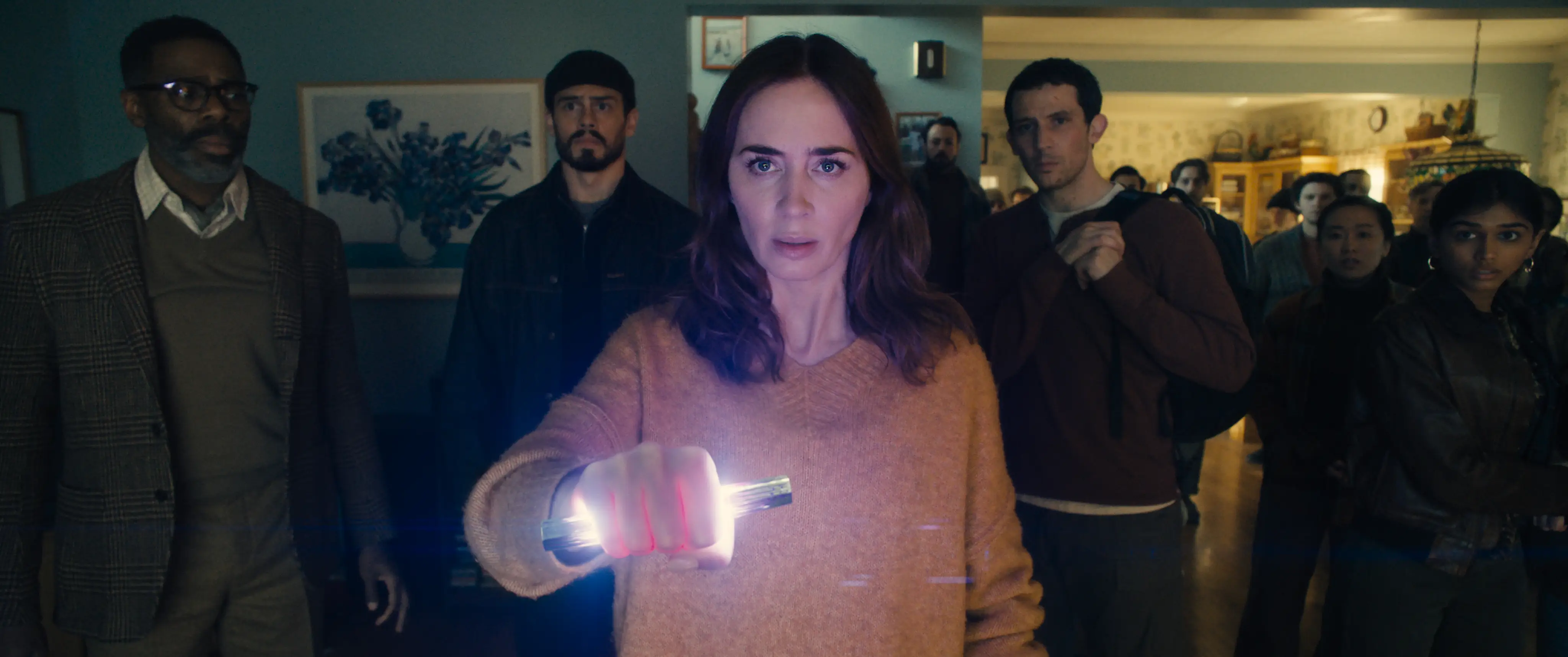Emily Blunt holding a glowing stick