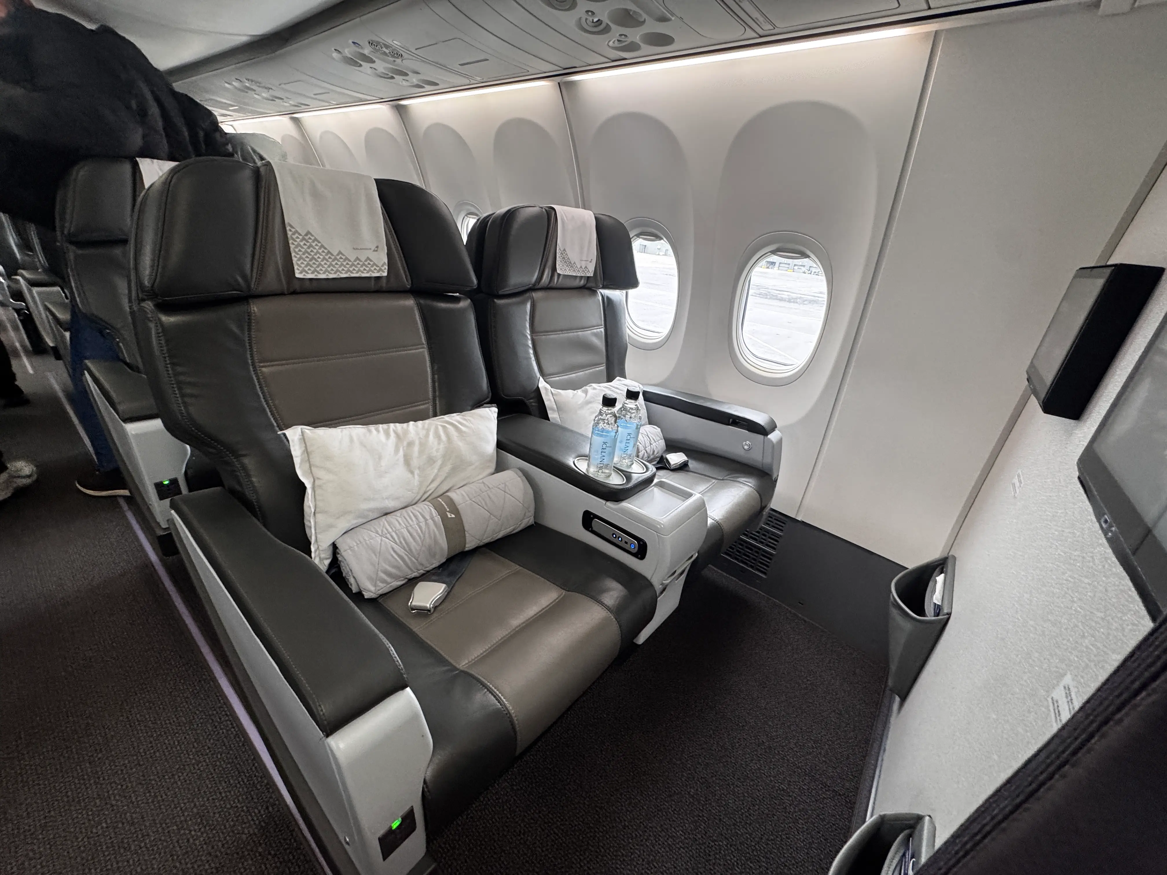 View of two IcelandAir Saga Premium seats next to plane window