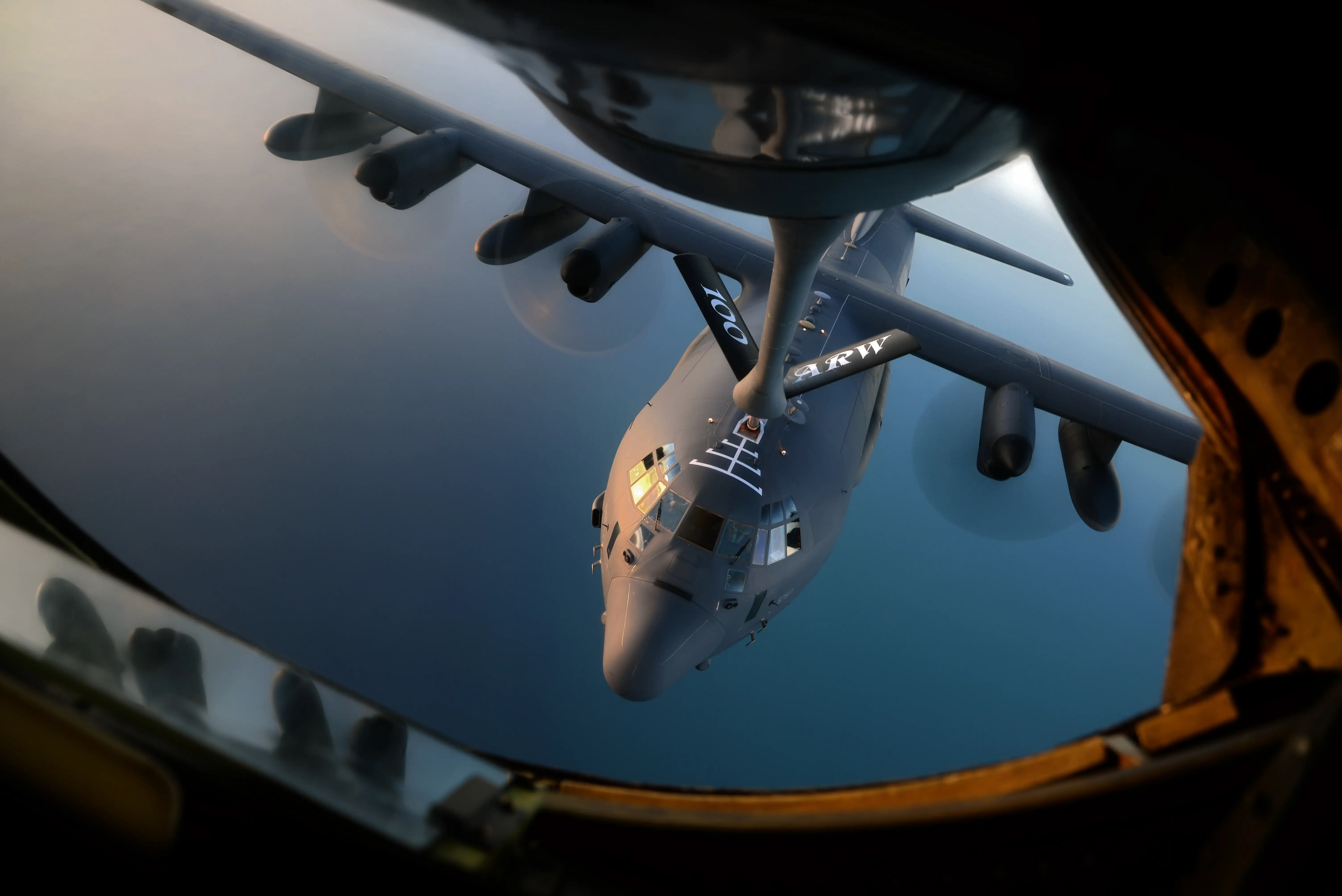 A KC-135 Stratotanker refuels a C-130 Hercules.