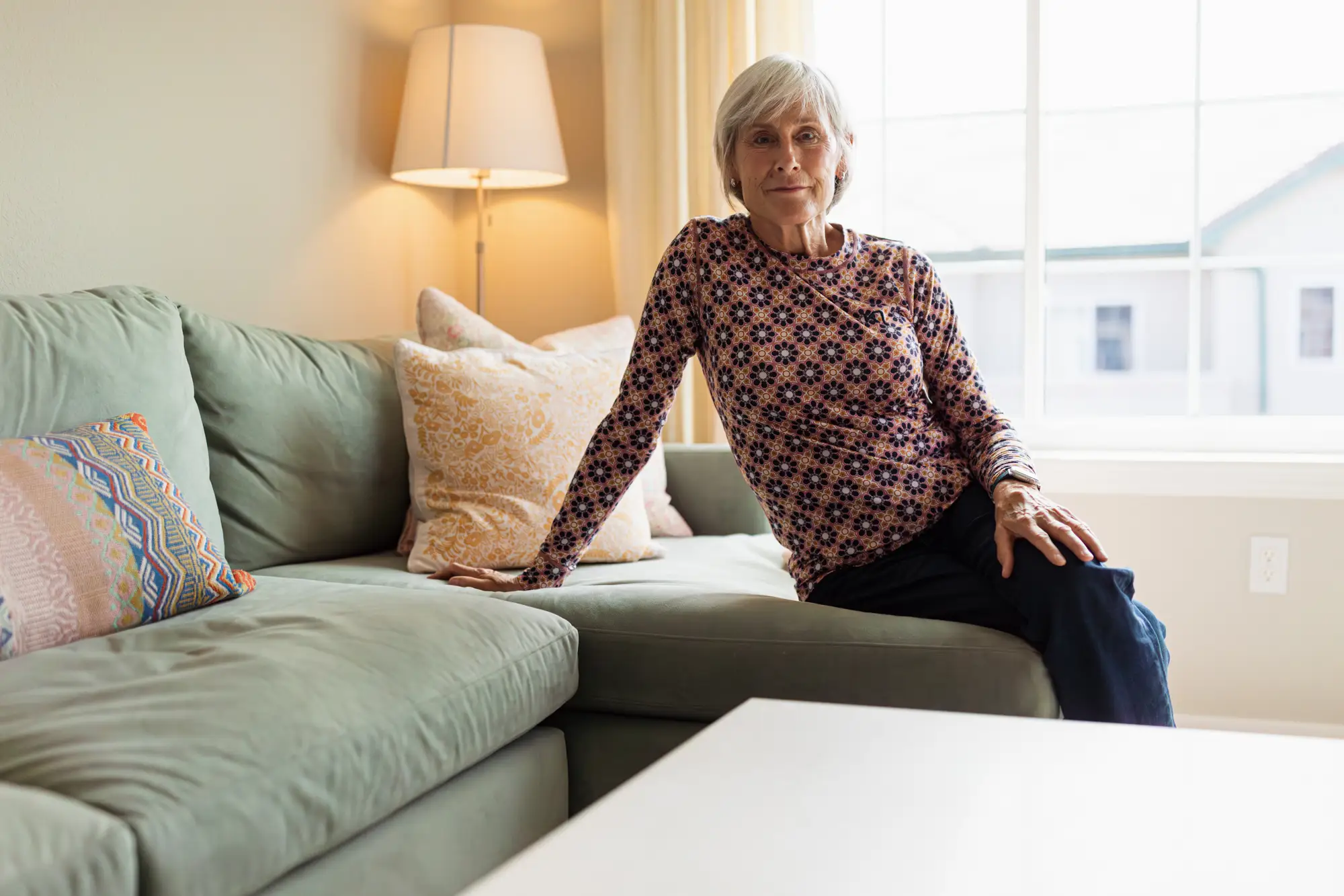 A woman sitting down on a couch.