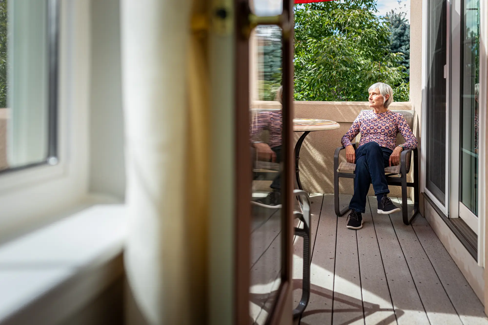 A woman sitting on an outdoor patio.