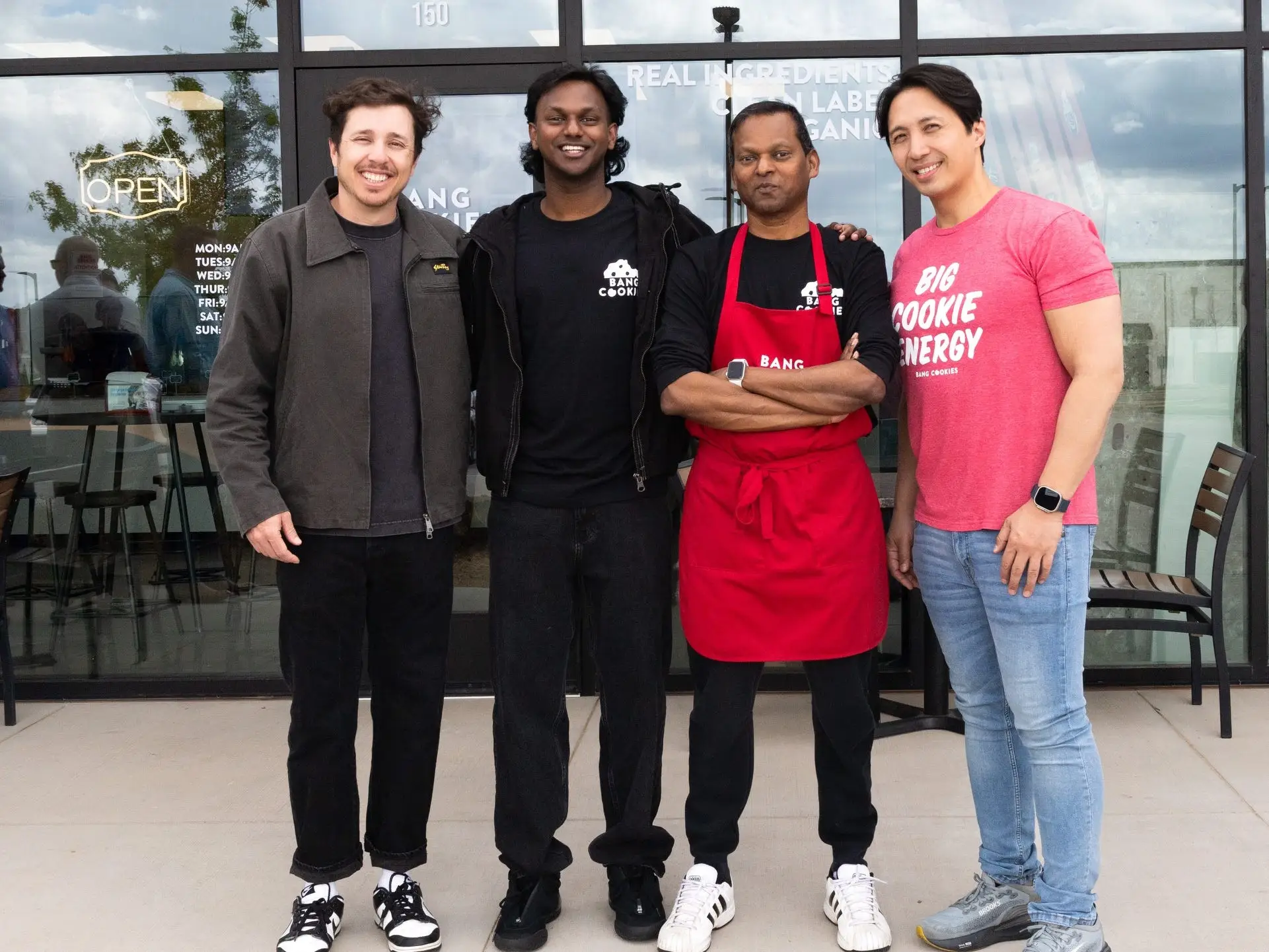 Corey Bonalewicz, Kugan Suppiah, Ganes Suppiah, and George Kuan pose at the grand opening of the Suppiah family's franchise.