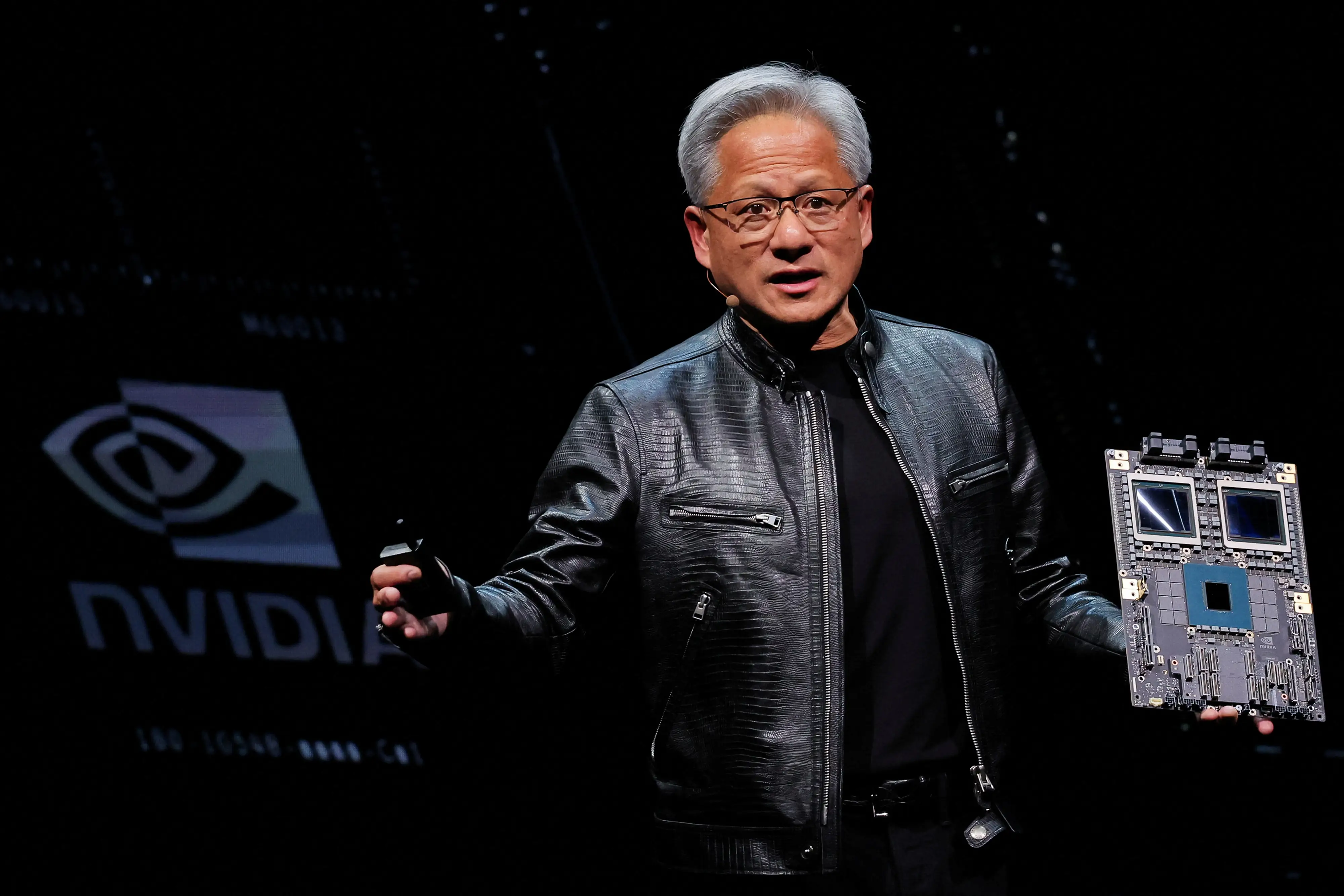 Nvidia CEO Jensen Huang shows off the company's Blackwell system on stage.