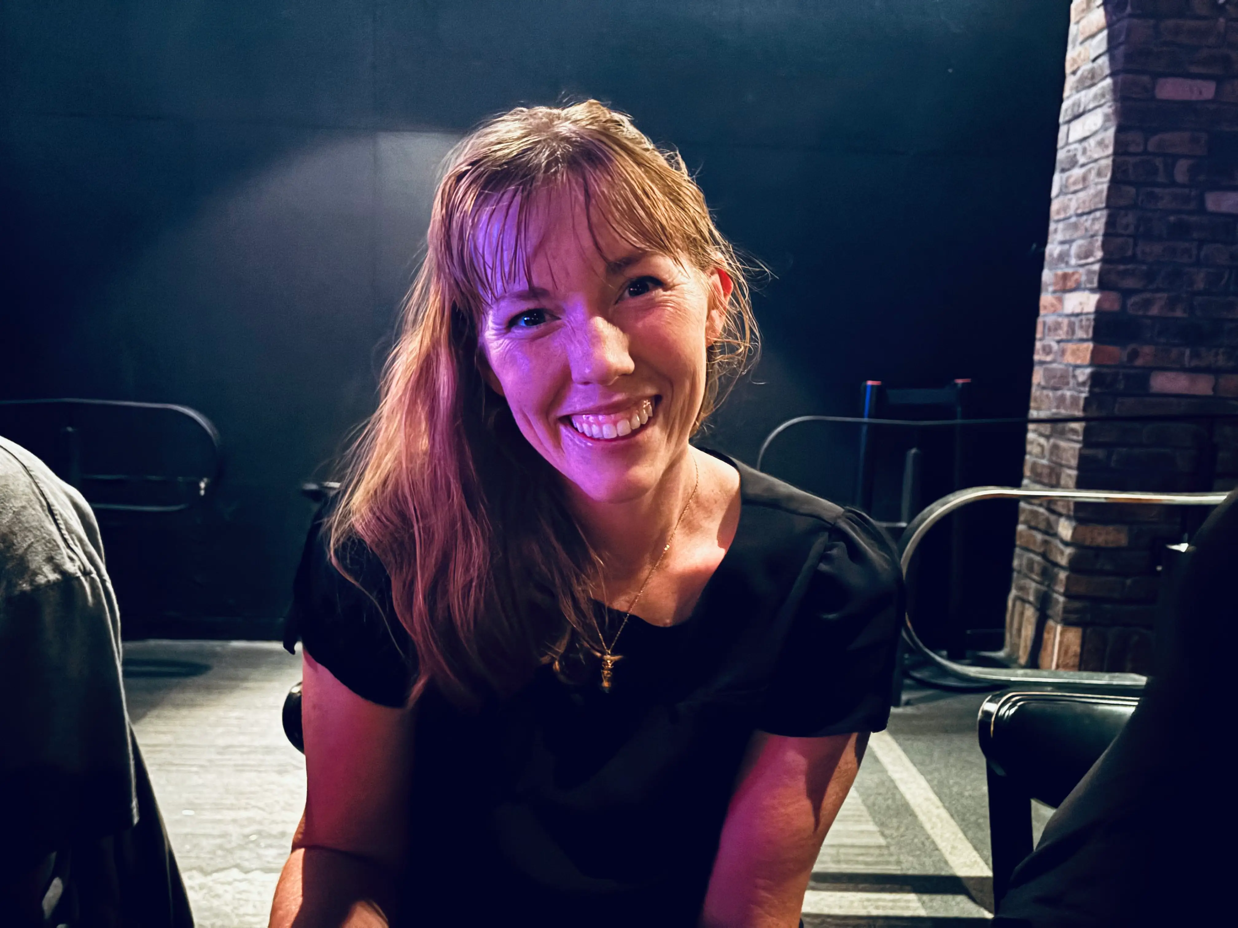 the author smiling and wearing a pineapple necklace