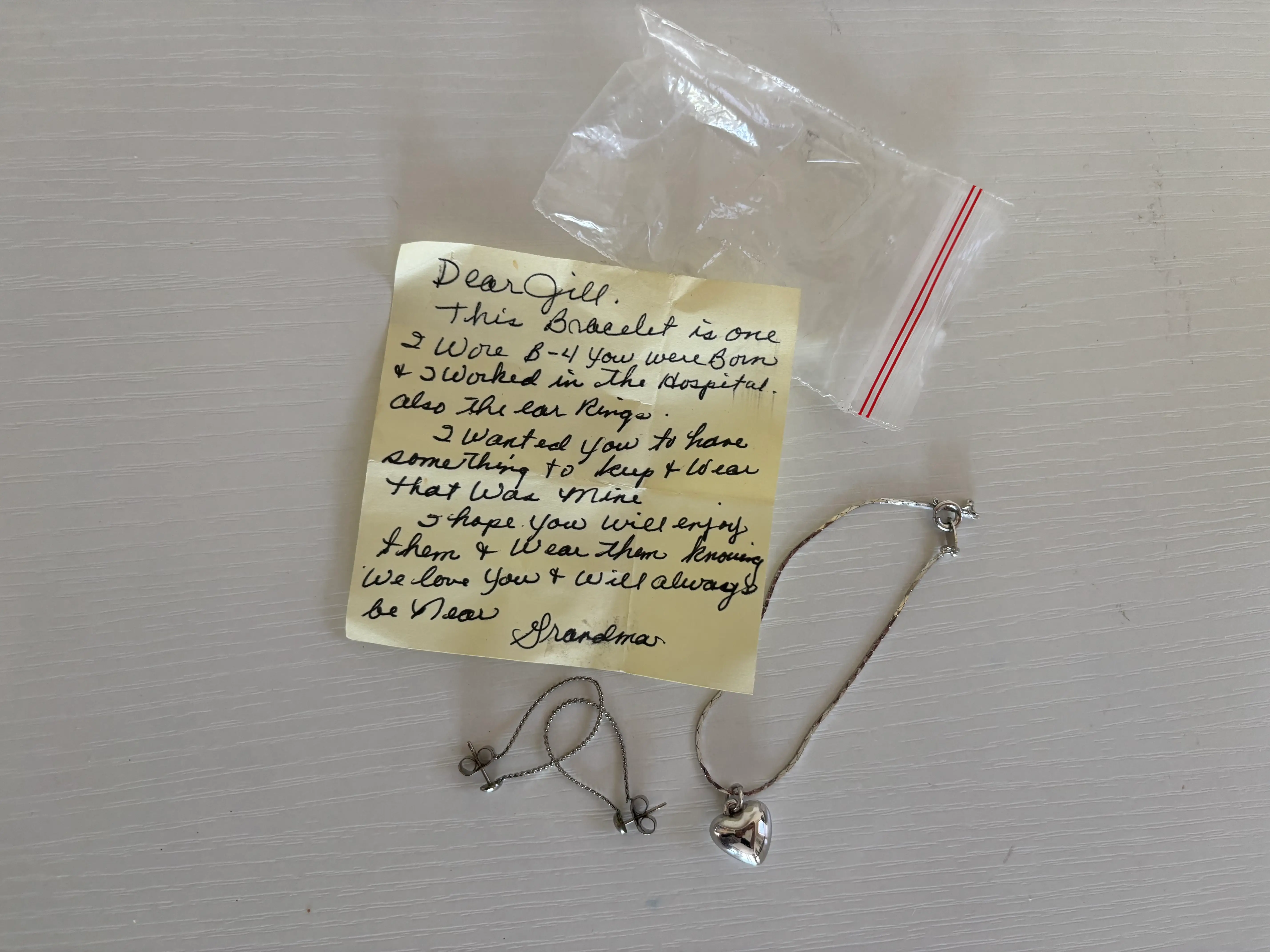 a bracelet and set of earrings in a bag with a handwritten note