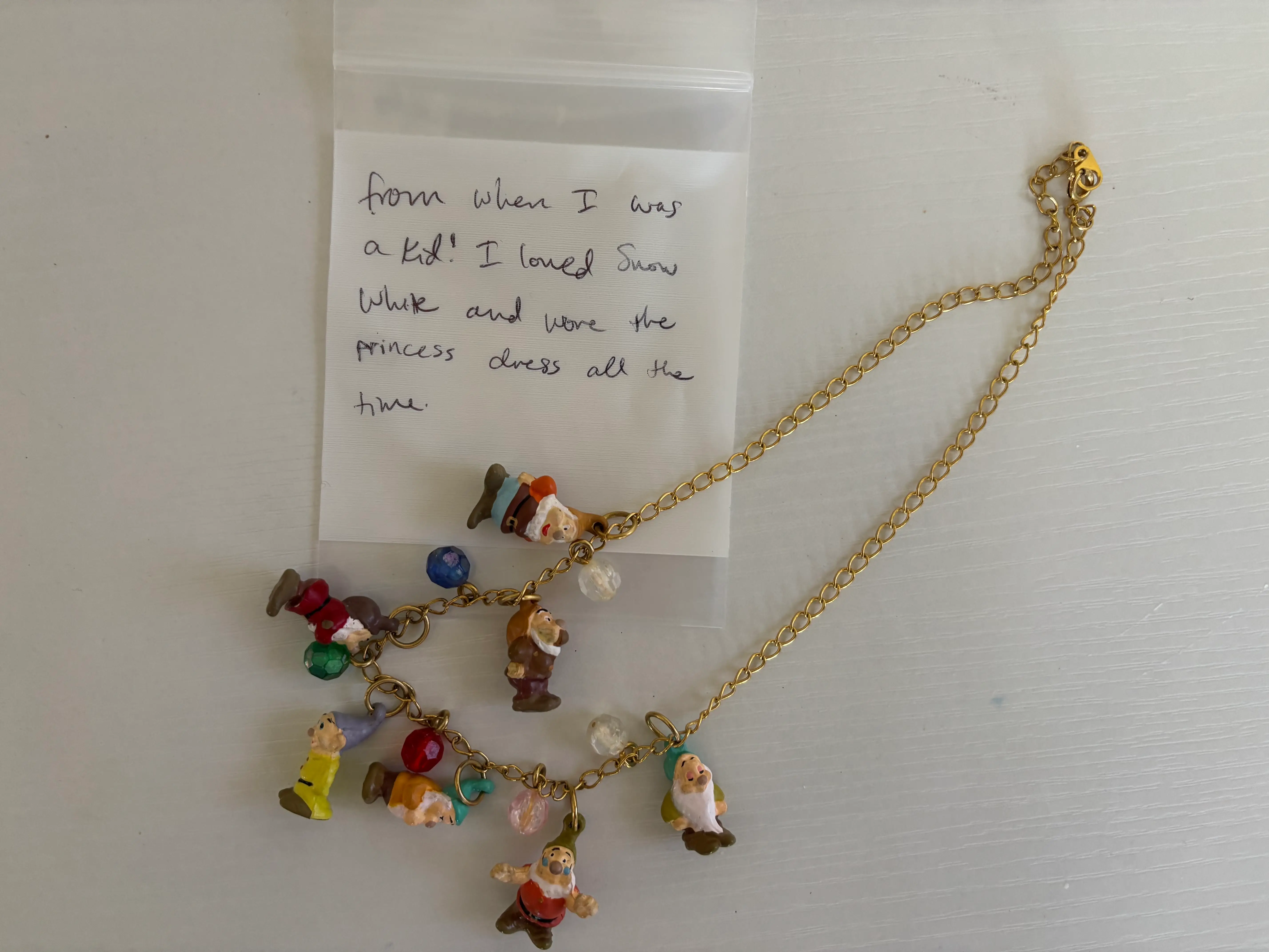 A necklace with the gnomes from Snow White as charms