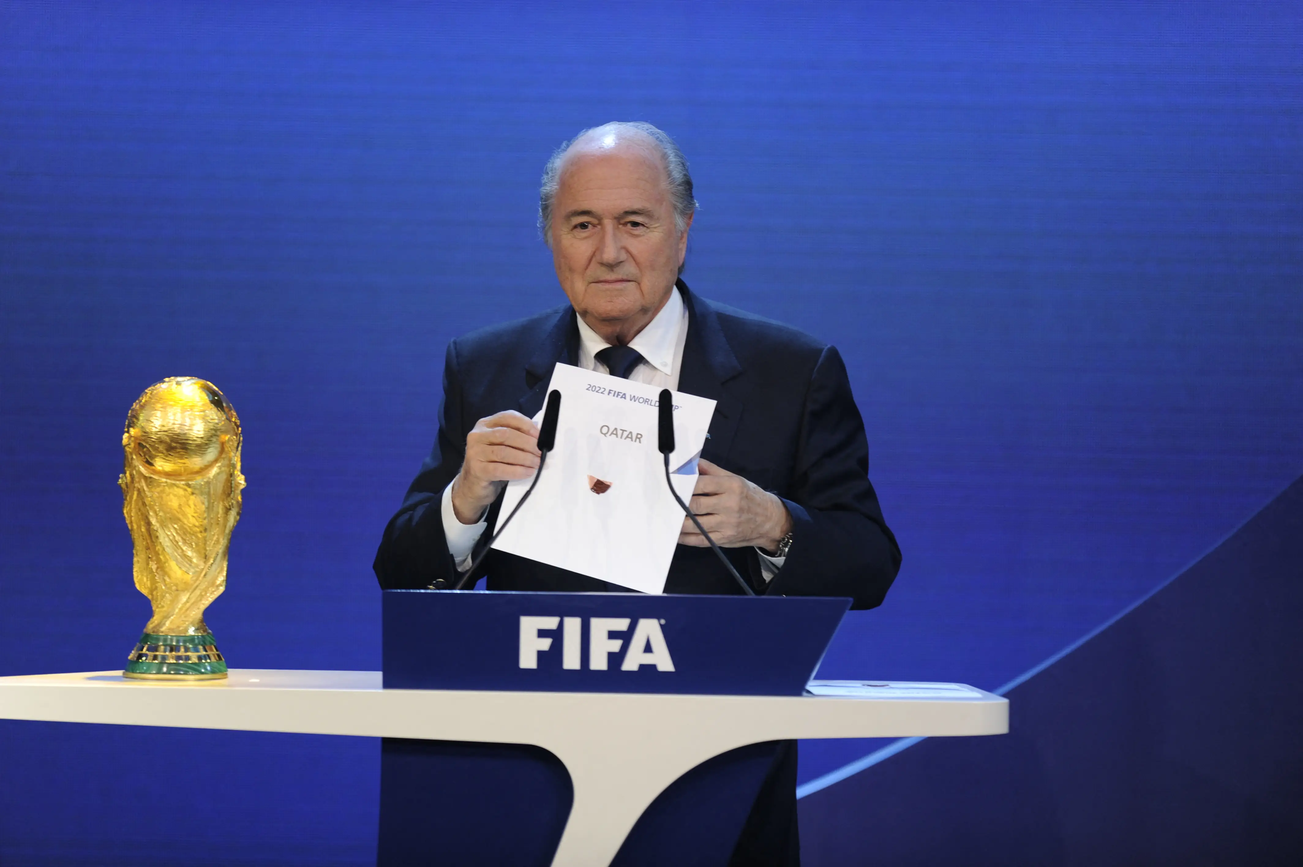 FIFA President Sepp Blatter holds up the name of Qatar during the official announcement of the 2022 World Cup host country.