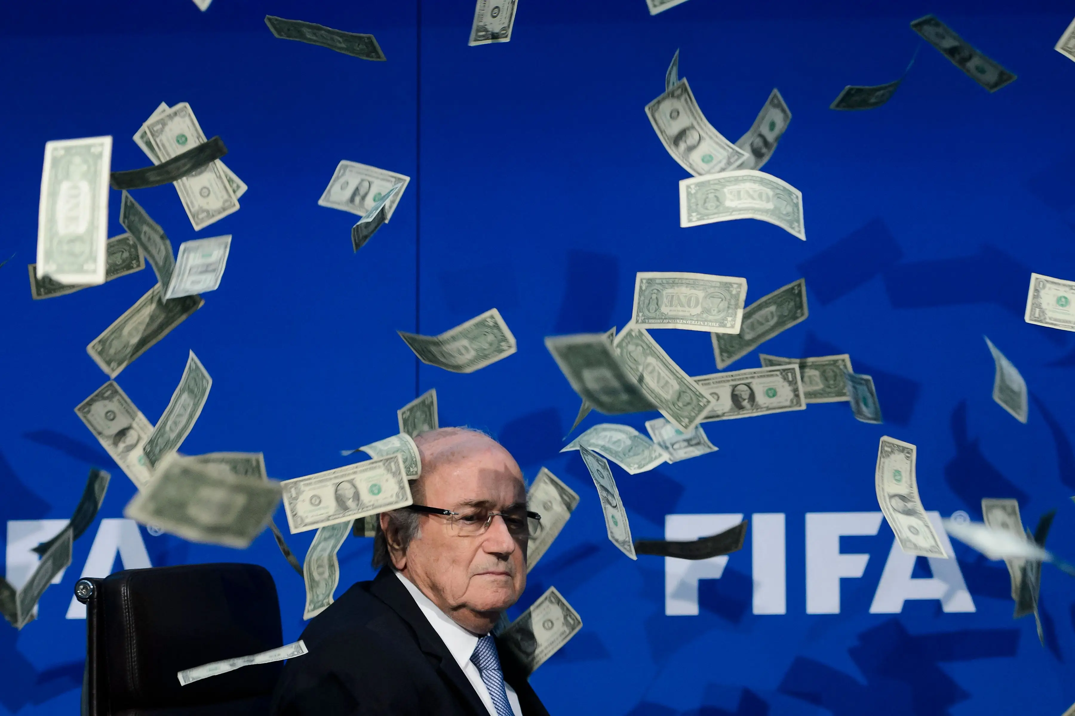 FIFA president Sepp Blatter looks on as fake dollars thrown by a protester fly around him in 2015 in Zurich.