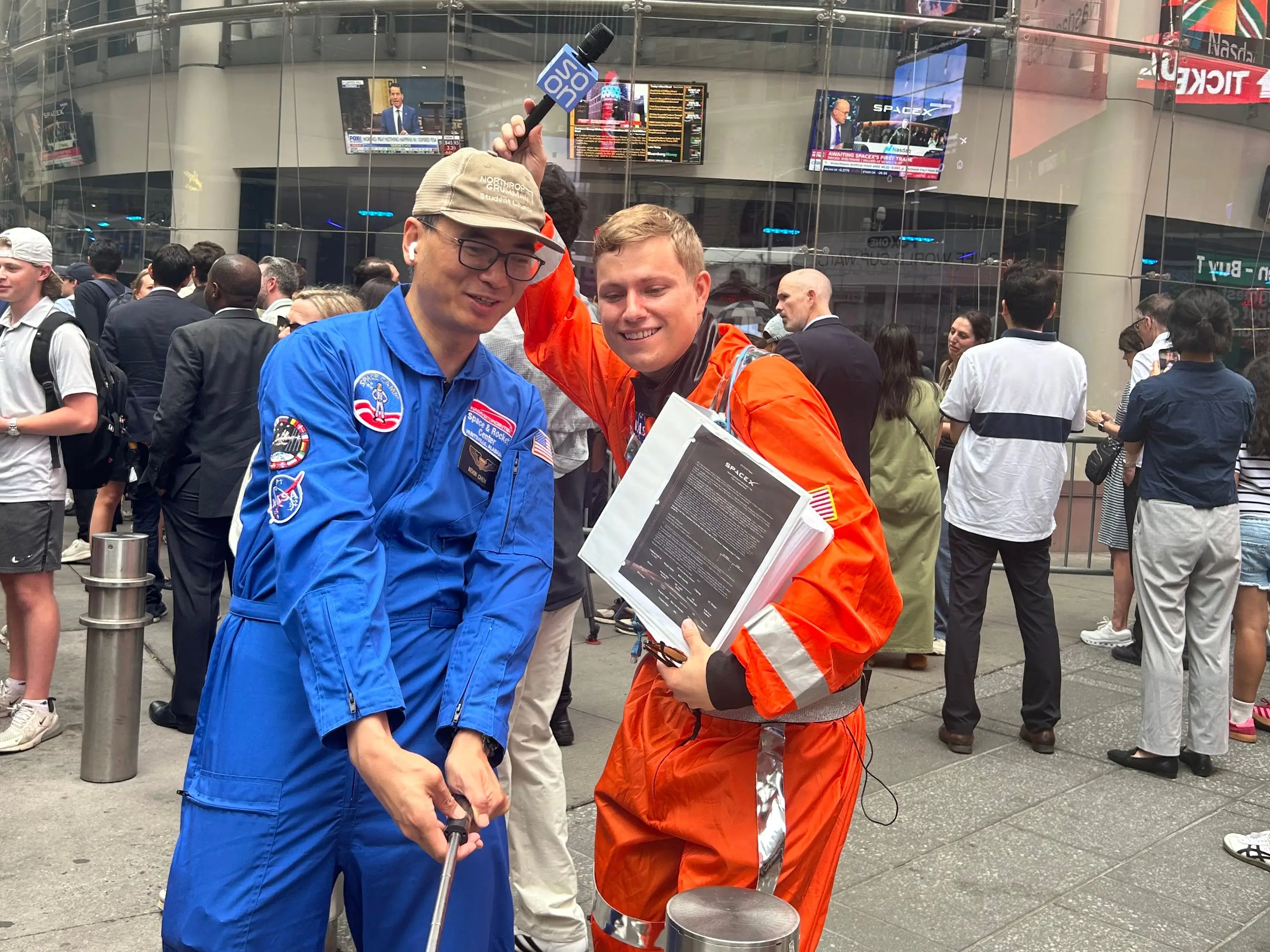 People dressed as astronauts in front of Nasdaq HQ on SpaceX IPO launch day.