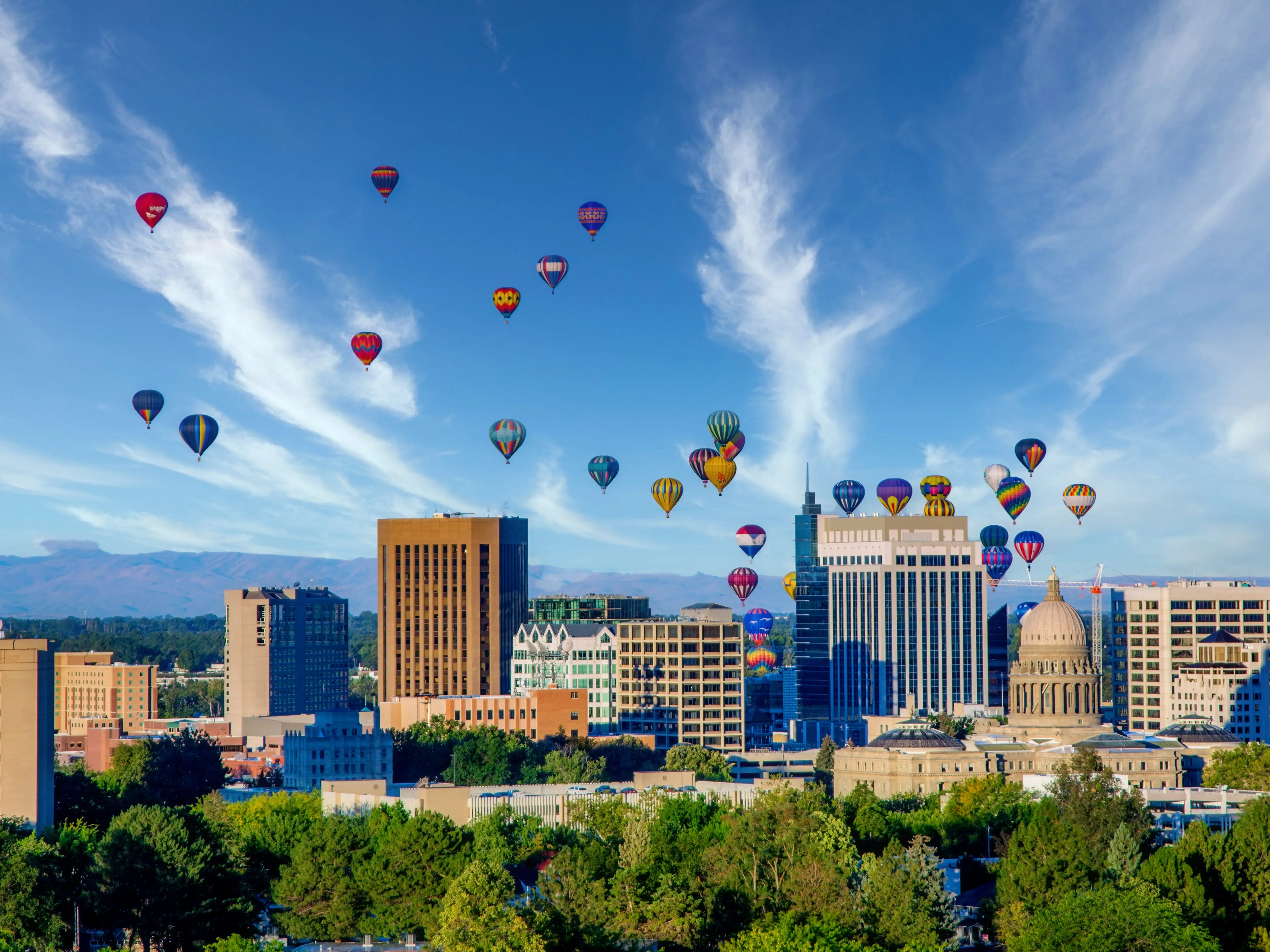 Cloudy sky over Boise with many hot air balloons