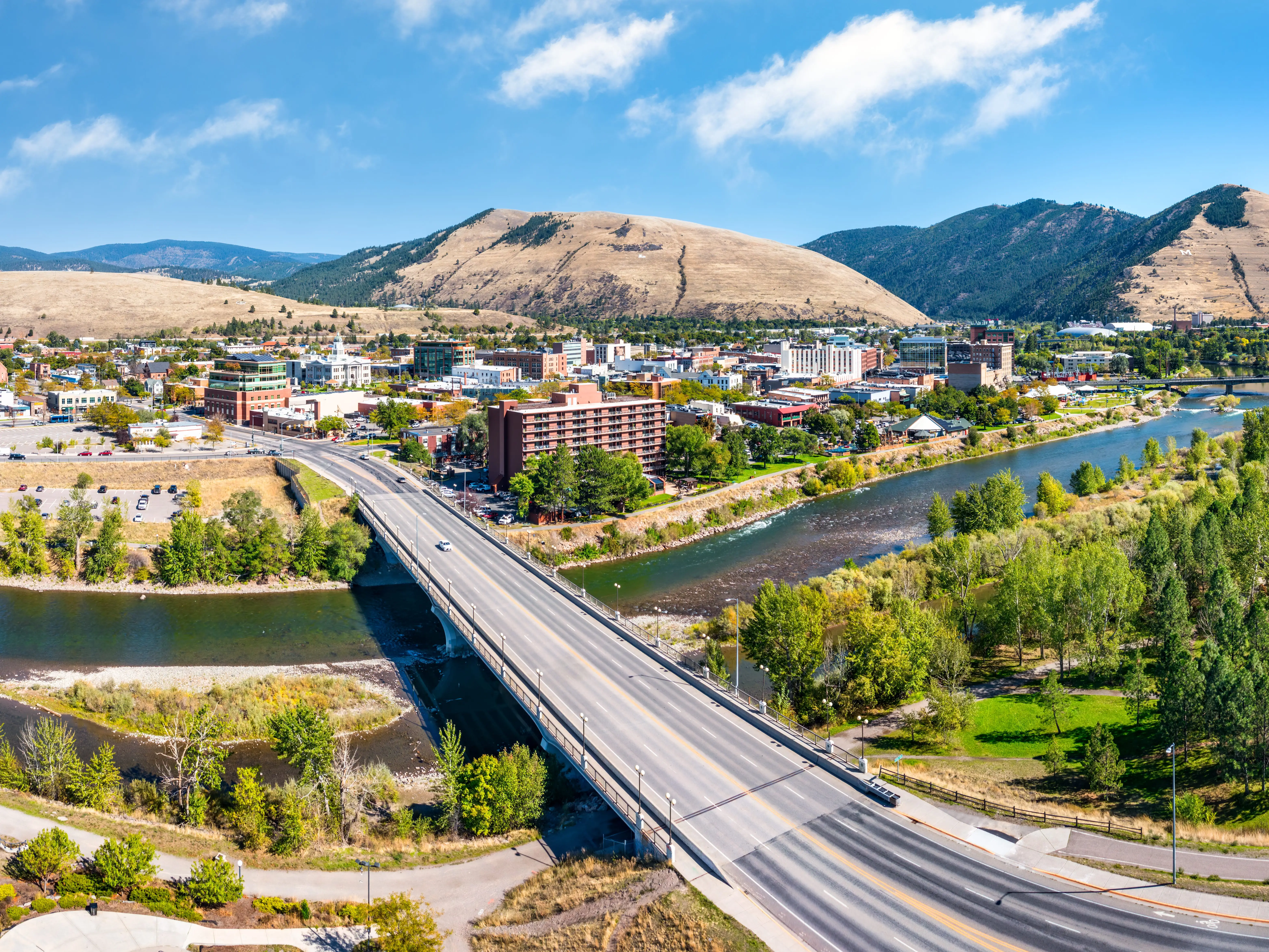 Aerial panorama of Missoula, Montana, above Beartracks Bridge. Missoula is a city in and the county seat of Missoula County, Montana. It is located along the Clark Fork River.