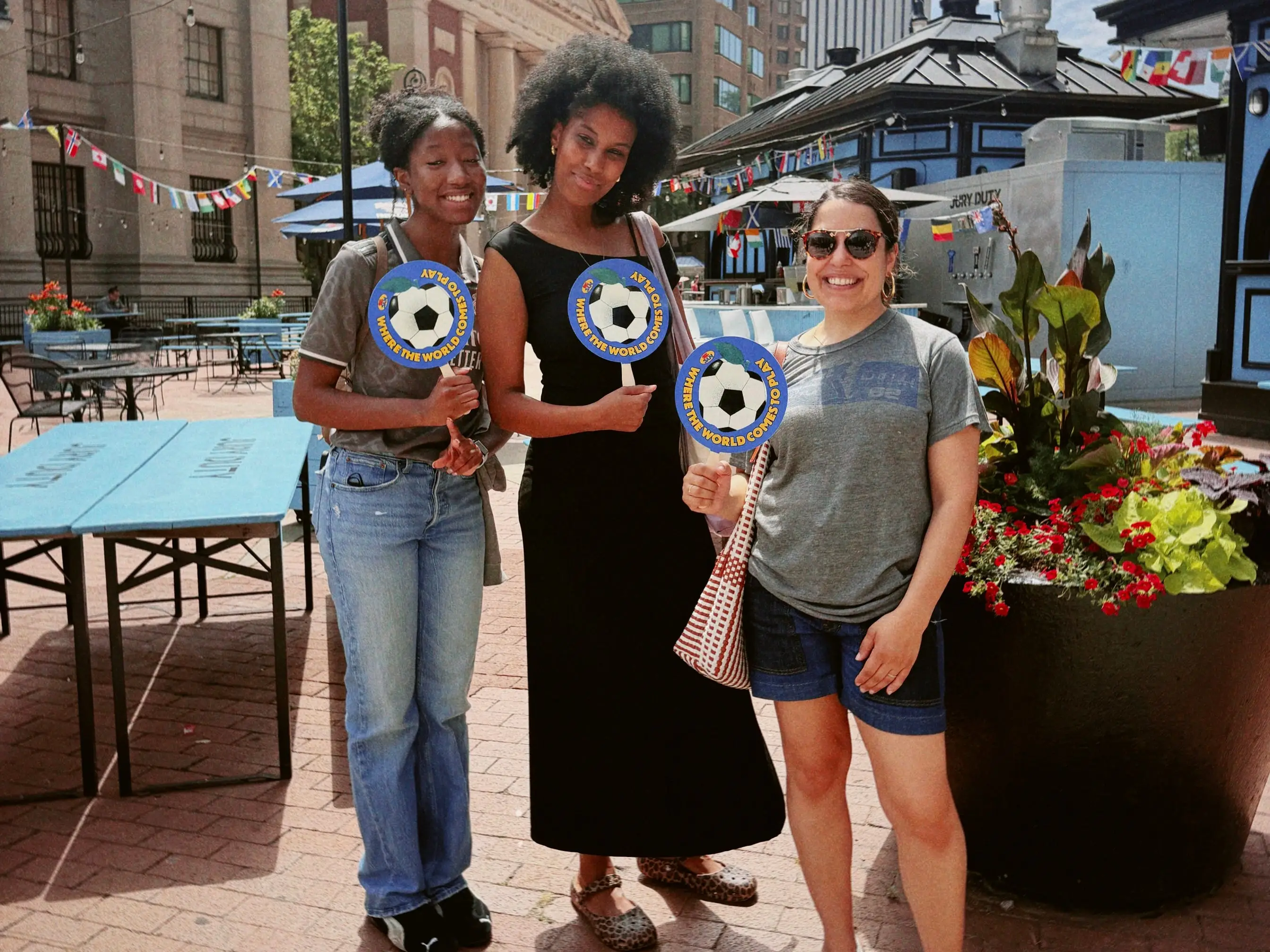 three women outside of city hall waiting for jerseys