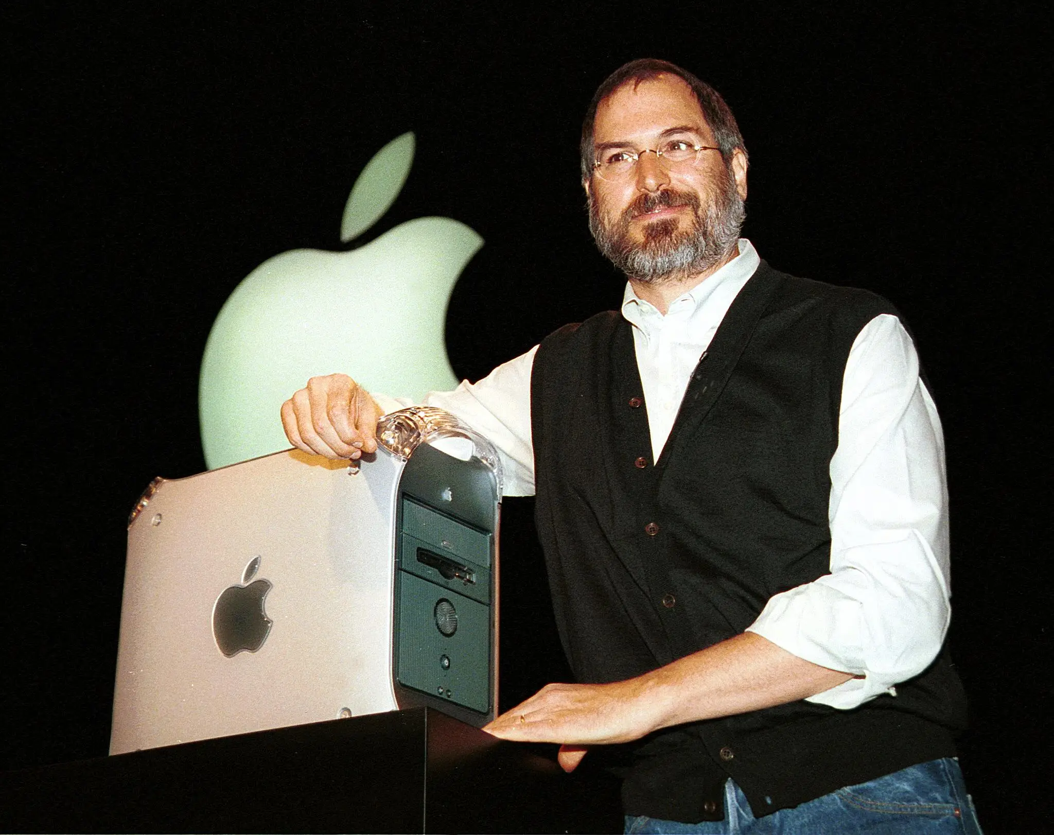 Steve Jobs stands on stage in 1999 with a Mac G4 desktop tower system.