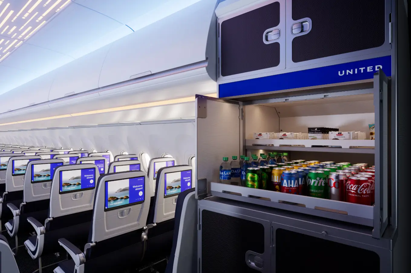United airplane cabin with seatback screens and an open beverage galley stocked with soft drinks and bottled water.
