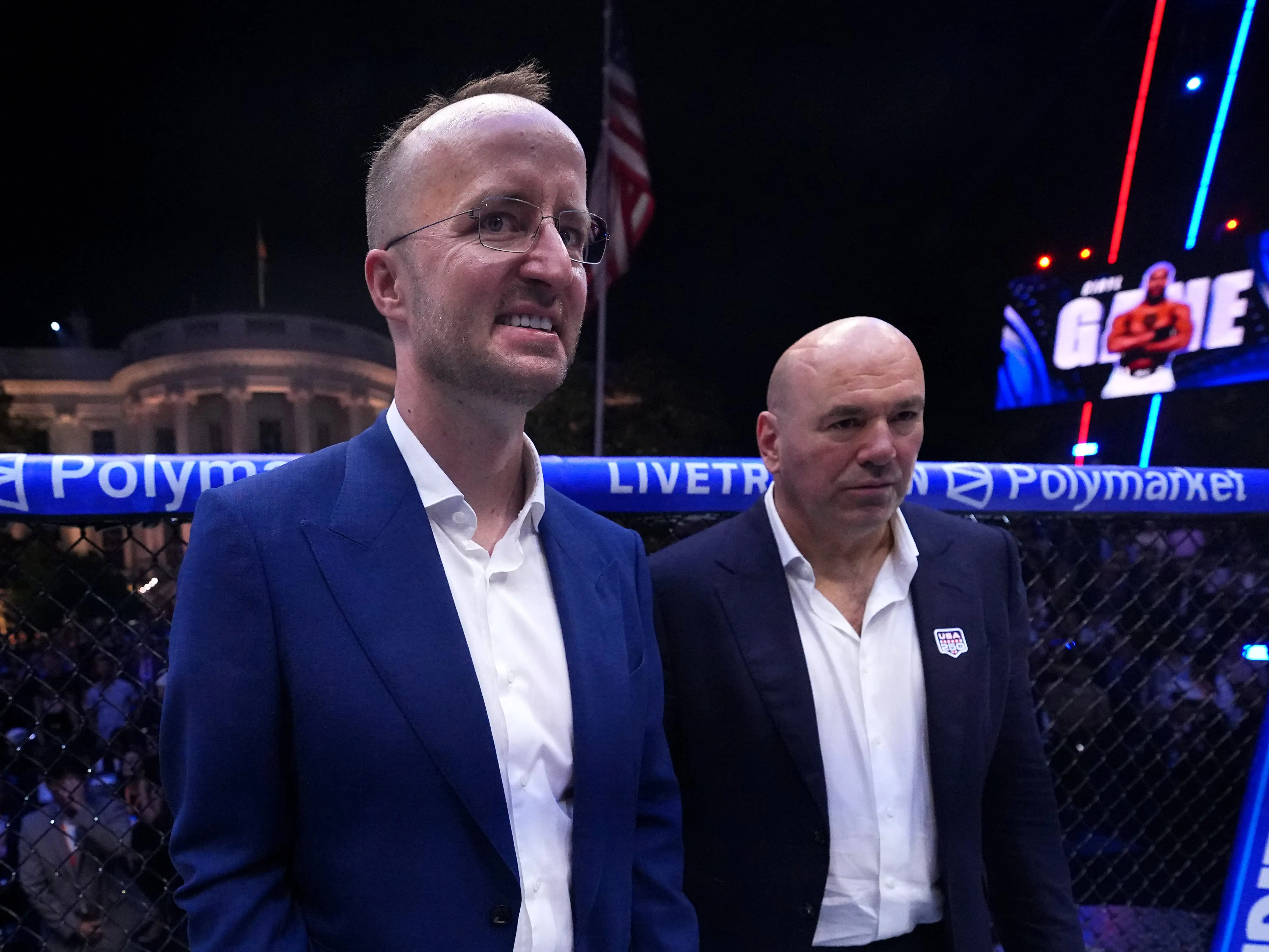 Kris Marszalek holding a championship belt next to Dana White