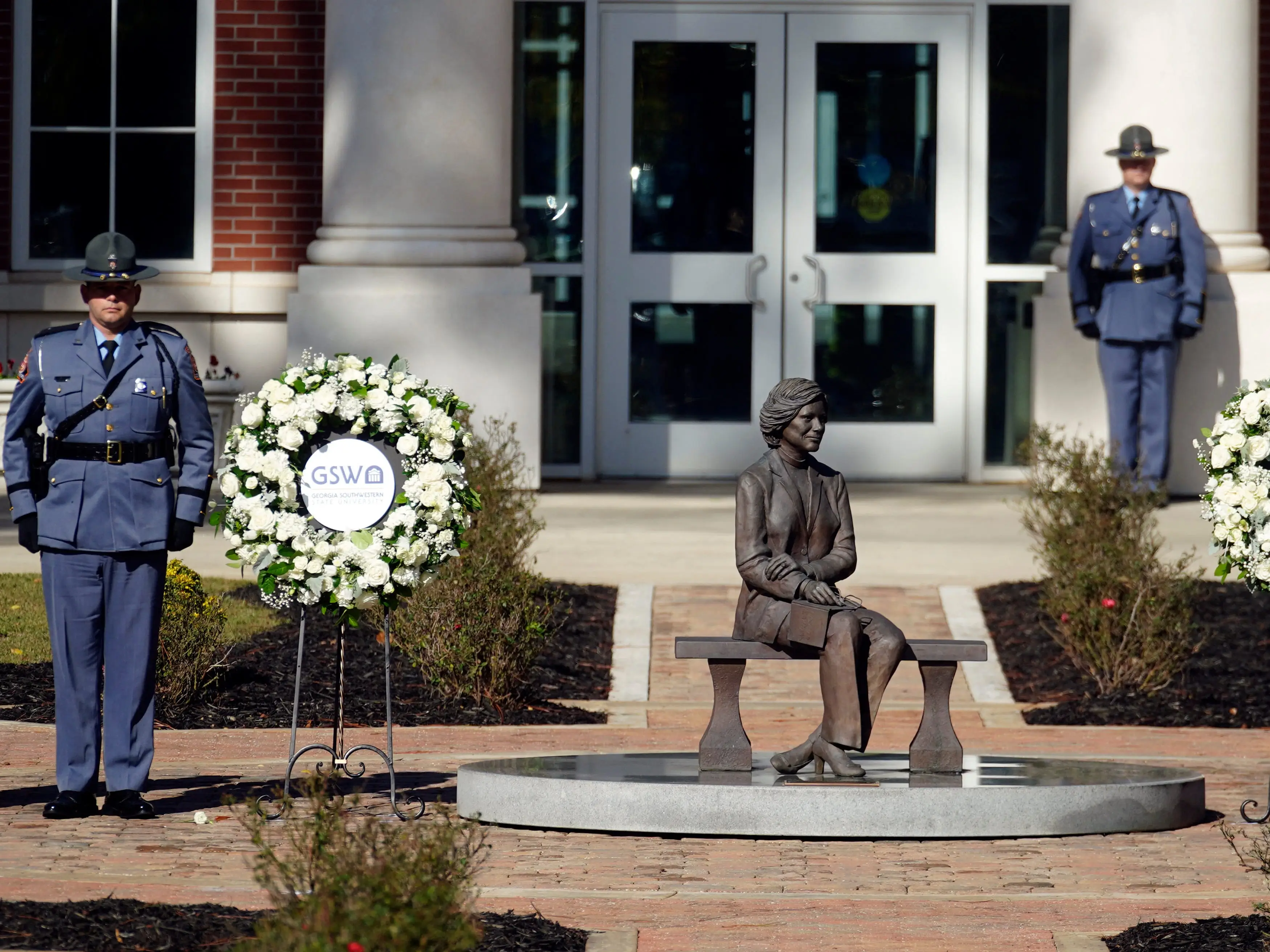 An honor guard stands near the wreath's and a statue of former first lady Rosalynn Carter at the Rosalynn Carter Health & Human Services complex on the campus of Georgia Southwestern State University, in Americus, Georgia, on November 27, 2023.