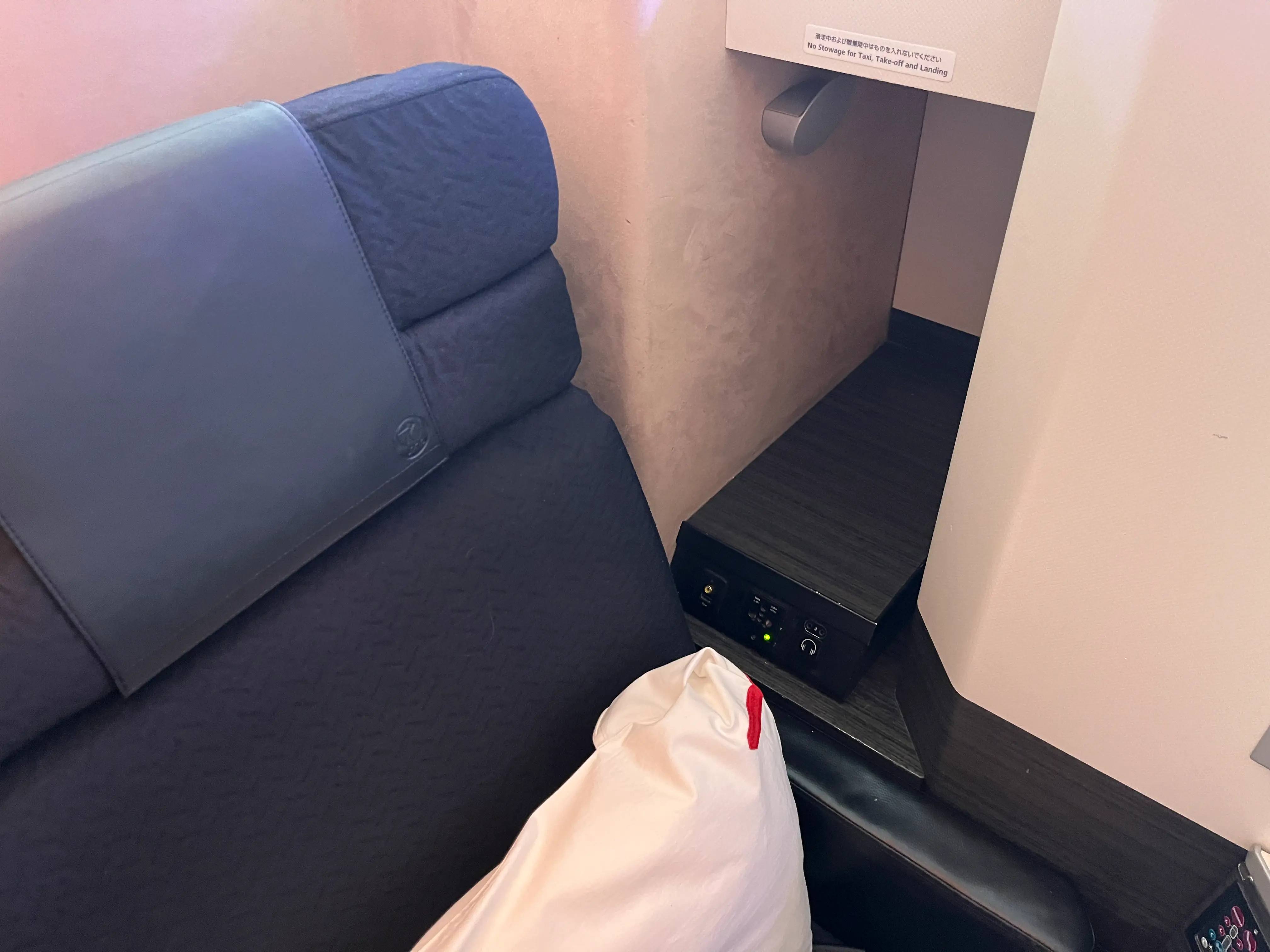 Storage cubby on flight with headphone plug-in spot below