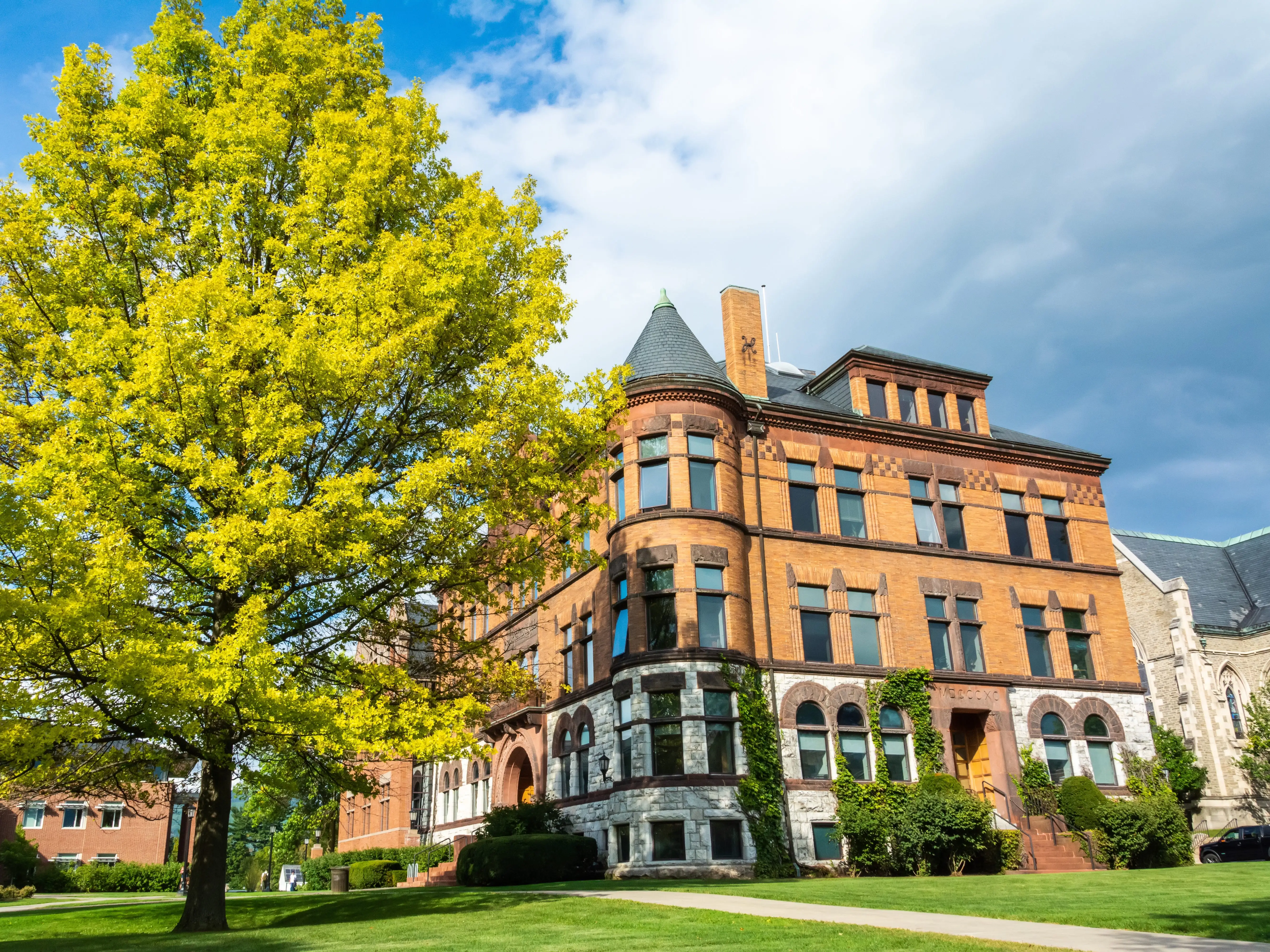 Williamstown, Massachusetts, USA - September 14, 2016. Hopkins Hall of the Williams College in Williamstown, MA. The building houses the Office of the President. View with vegetation and car.