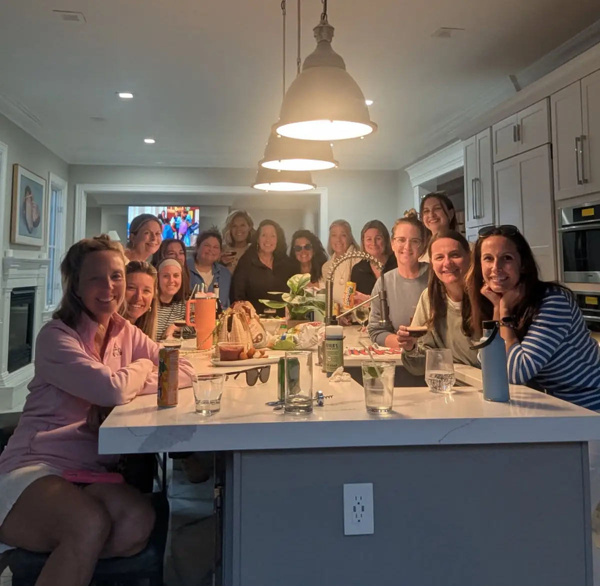 Kerry Feeney and her friends are pictured in the kitchen of the house from