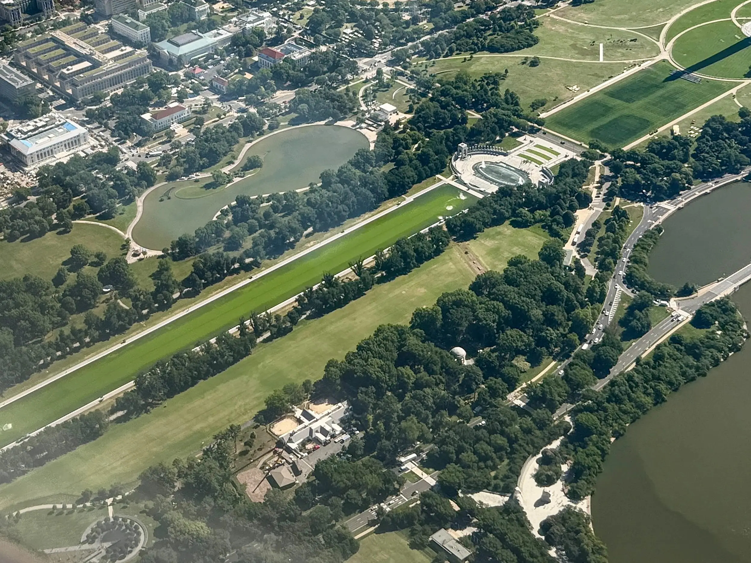 WASHINGTON, DC - JUNE 16: Water in the Lincoln Memorial Reflecting Pool (lower right) is shown from a departing flight from Ronald Reagan National Airport as algae continues to bloom following the completion of recent renovations on June 16, 2026 in Washington, DC.