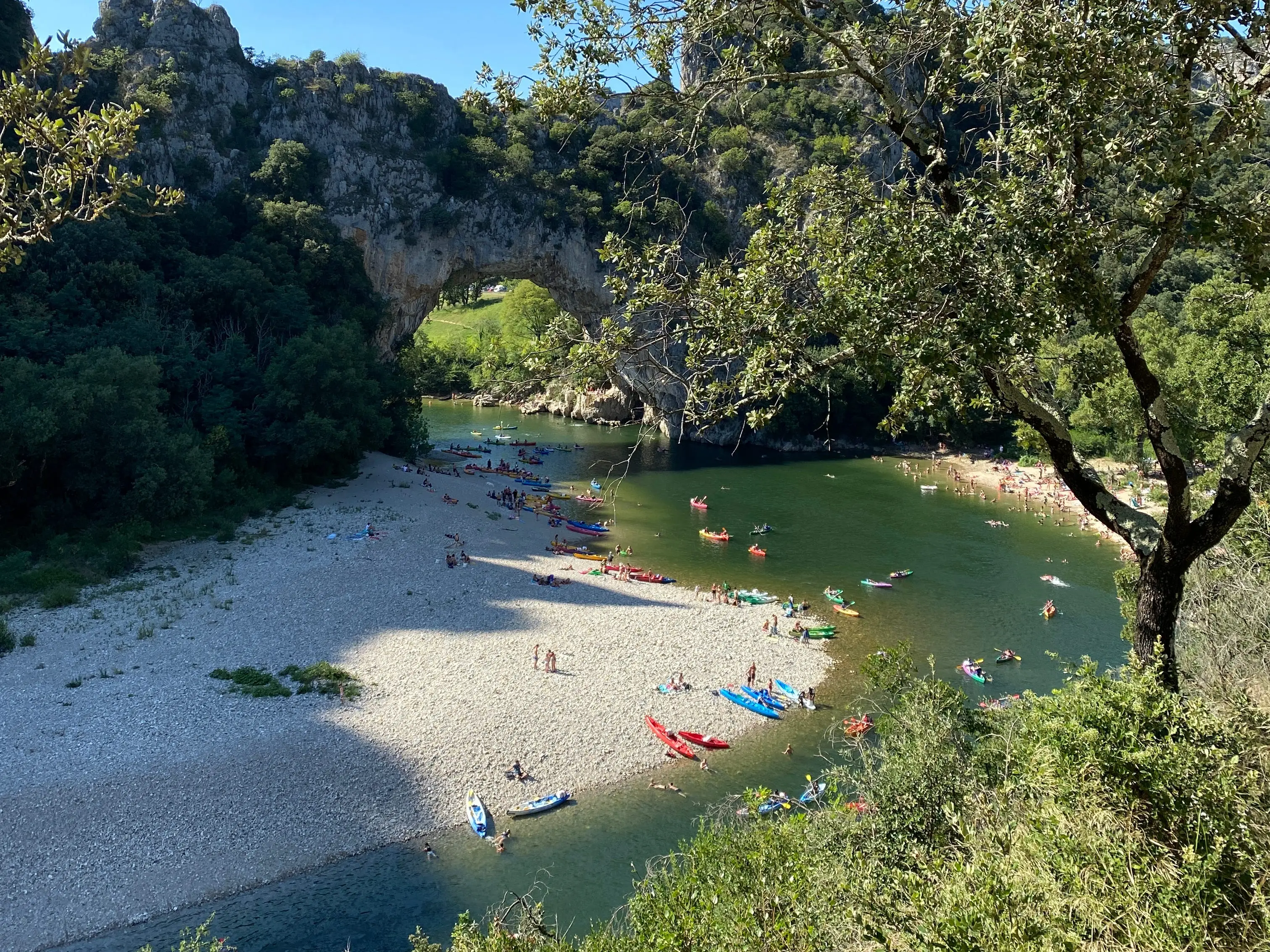 An overhead shot of a beach, water, and kayaks in France.