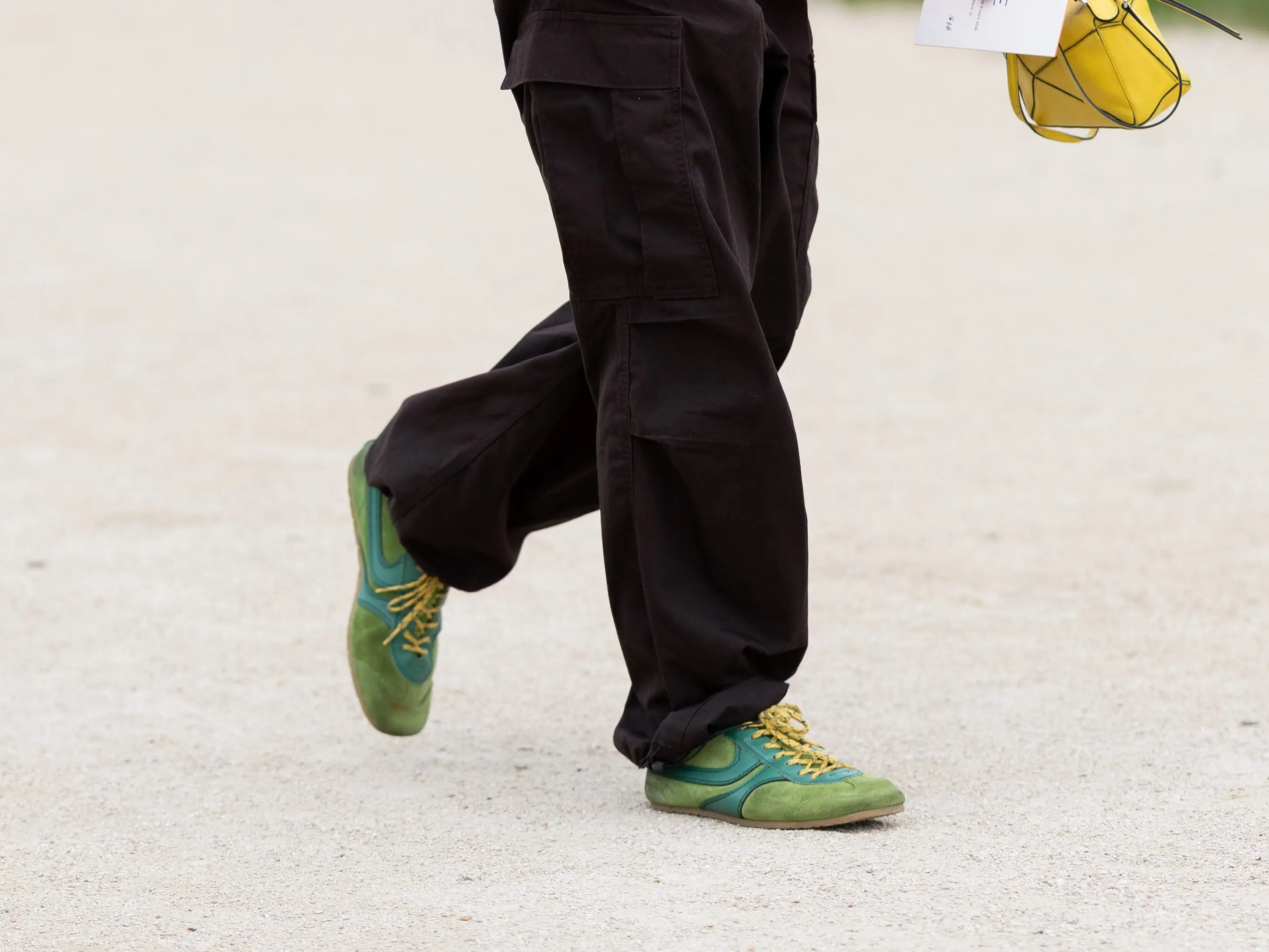 A man wears suede sneakers during Paris Fashion Week.