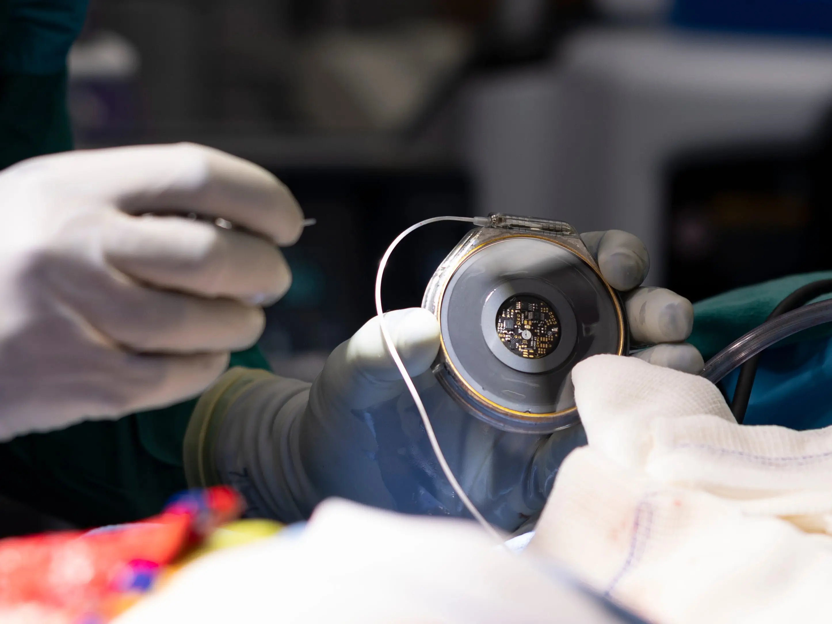 A doctor holds a device in their hands.
