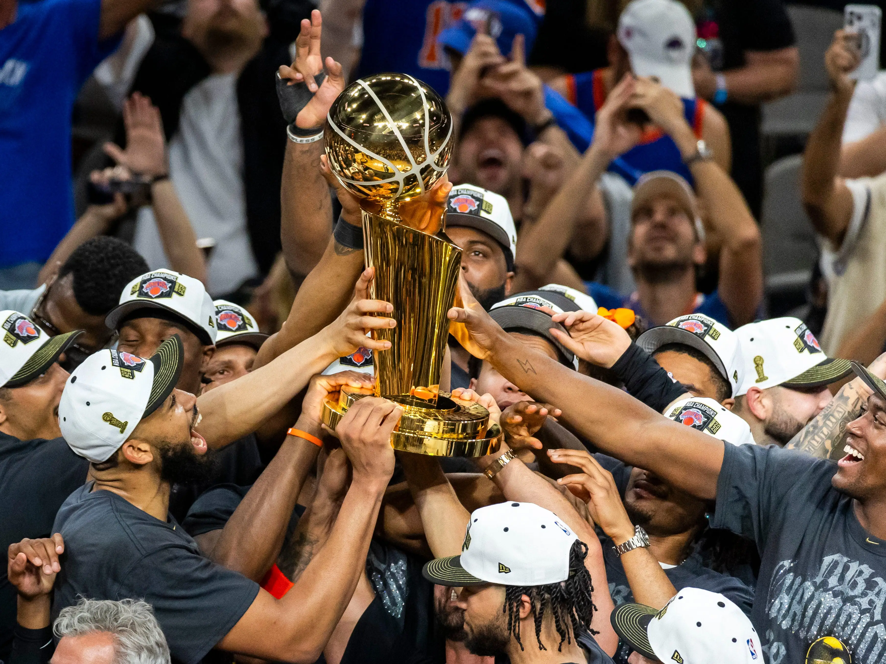 New York Knicks players celebrate while receiving the Larry O'Brien Championship Trophy after defeating the San Antonio Spurs 94-90 in Game 5 of the NBA Finals at Frost Bank Center in San Antonio on Saturday, June 13, 2026.