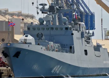 A Russian warship sailing between England and France fired warning shots at a British civilian yacht