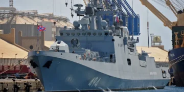 A Russian warship sailing between England and France fired warning shots at a British civilian yacht