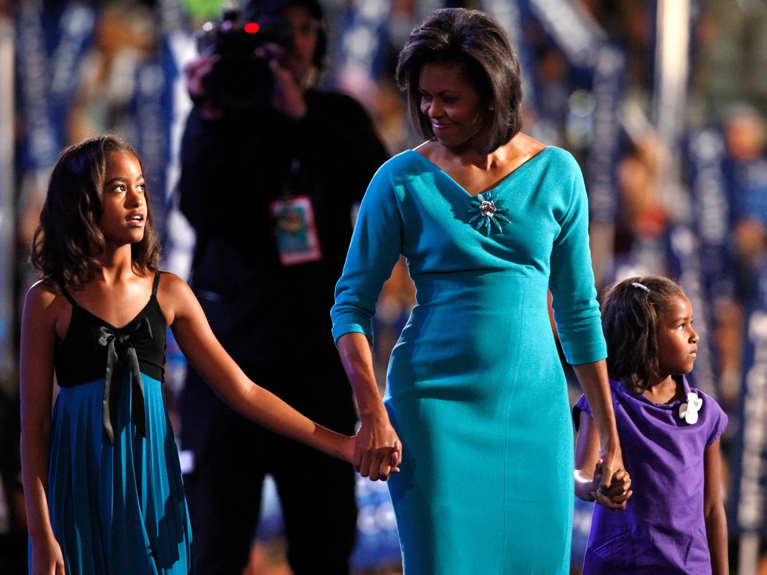 Michelle Obama attends the Democratic National Convention with her daughters in August 2008.