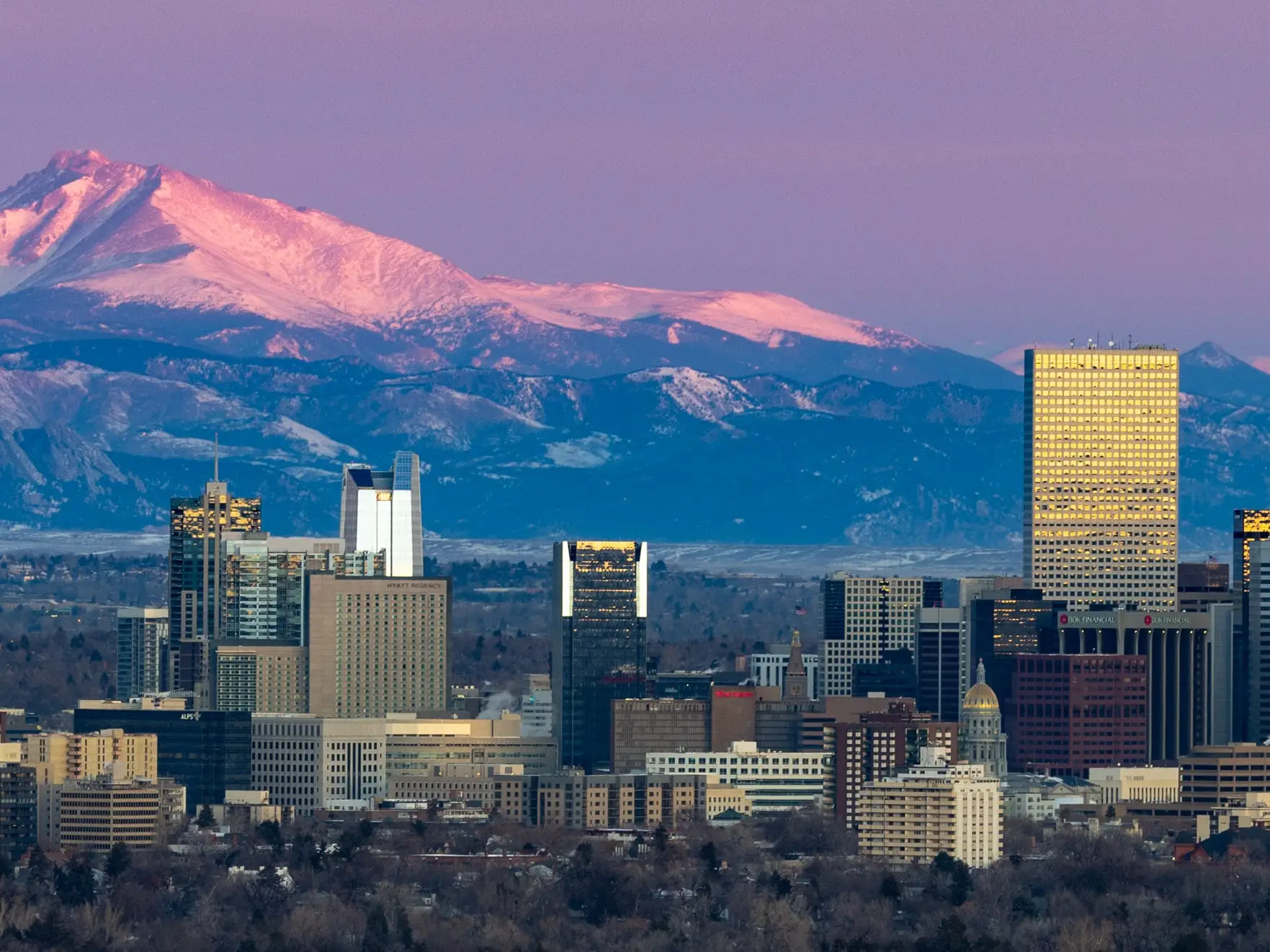 Varied view of Denver Colorado with prominent local mountain in background.