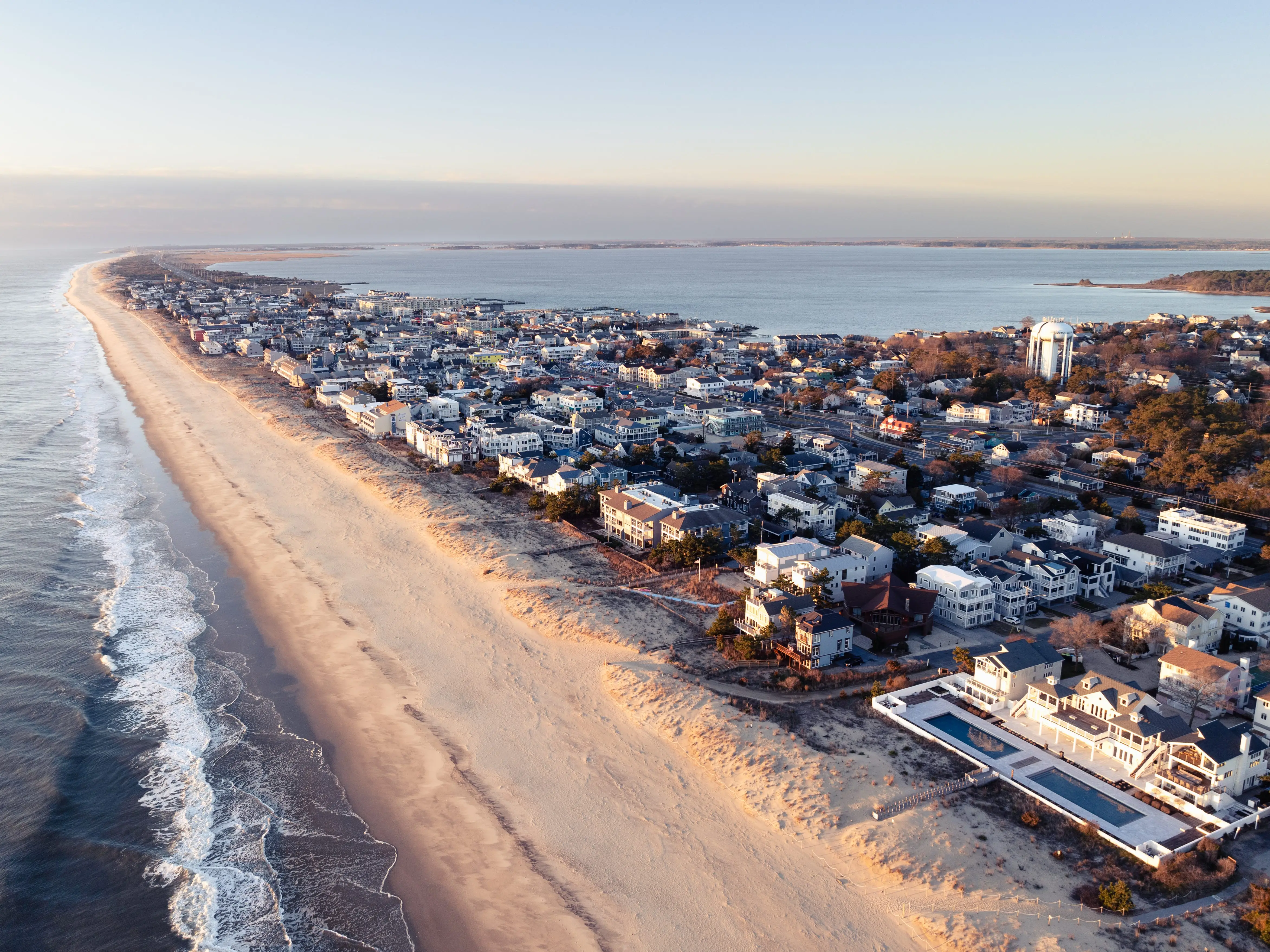 An aerial image of Dewey Beach, Delaware, looking south from the area near Chicago Street during a coastal sunrise