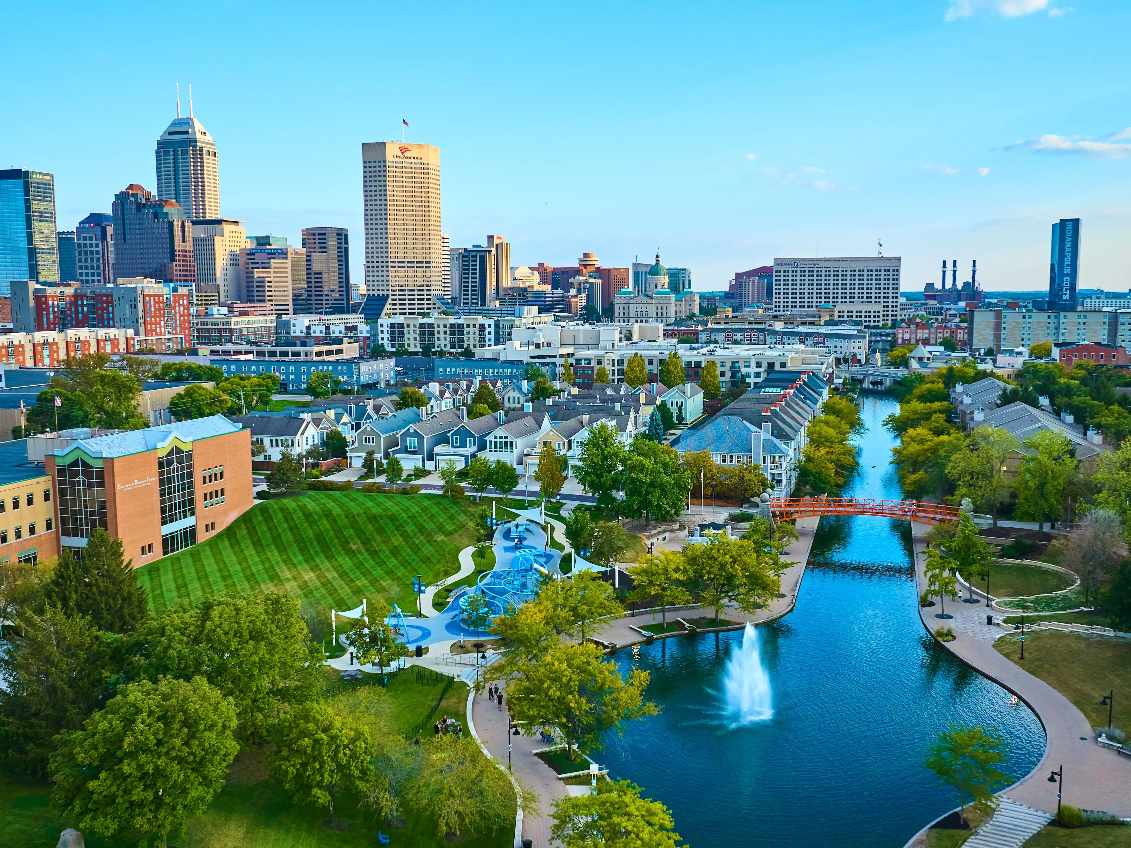 Aerial View of Vibrant Indianapolis Cityscape with Serene Park and Waterway at Golden Hour