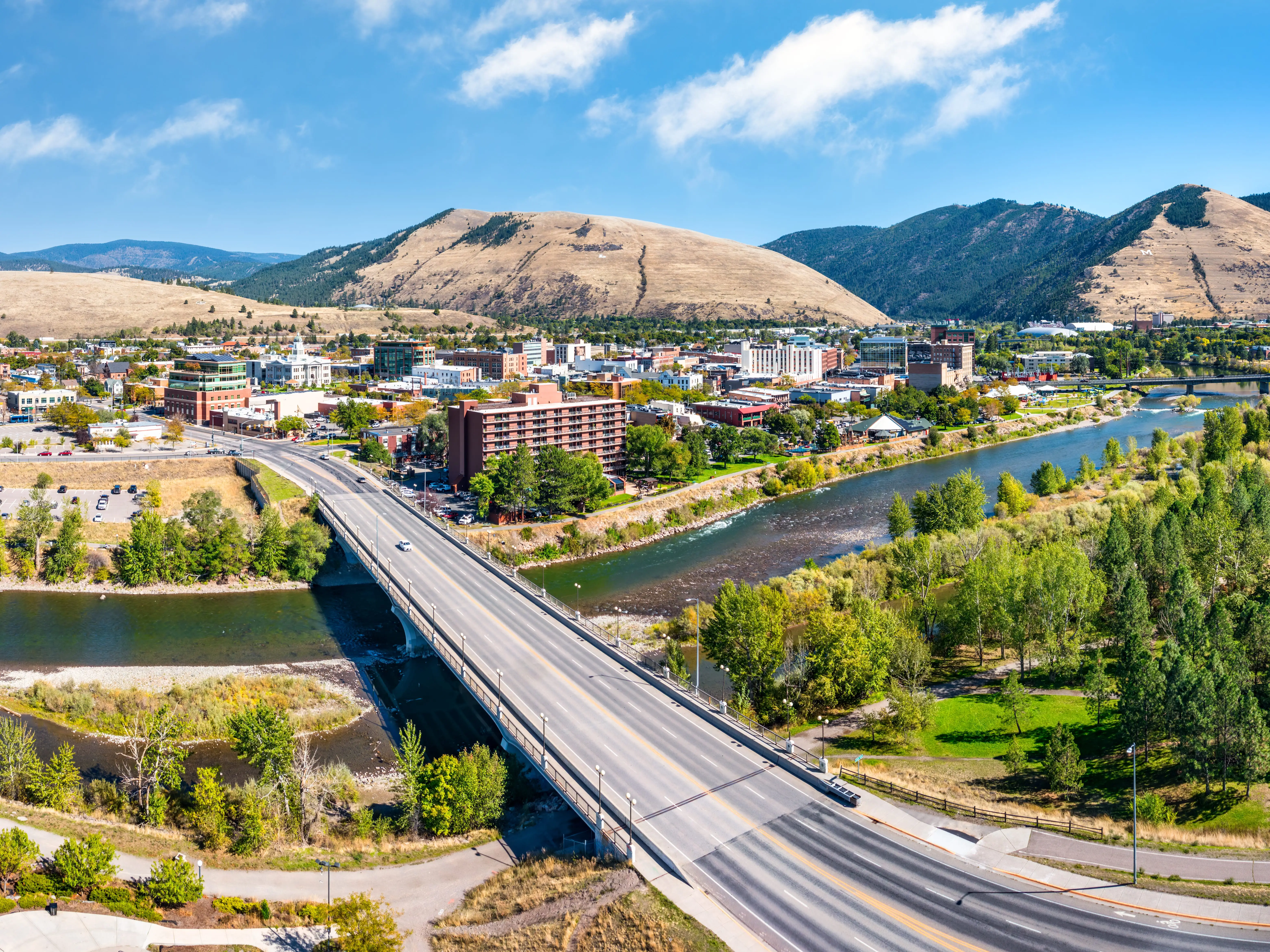 Aerial panorama of Missoula, Montana, above Beartracks Bridge. Missoula is a city in and the county seat of Missoula County, Montana. It is located along the Clark Fork River.