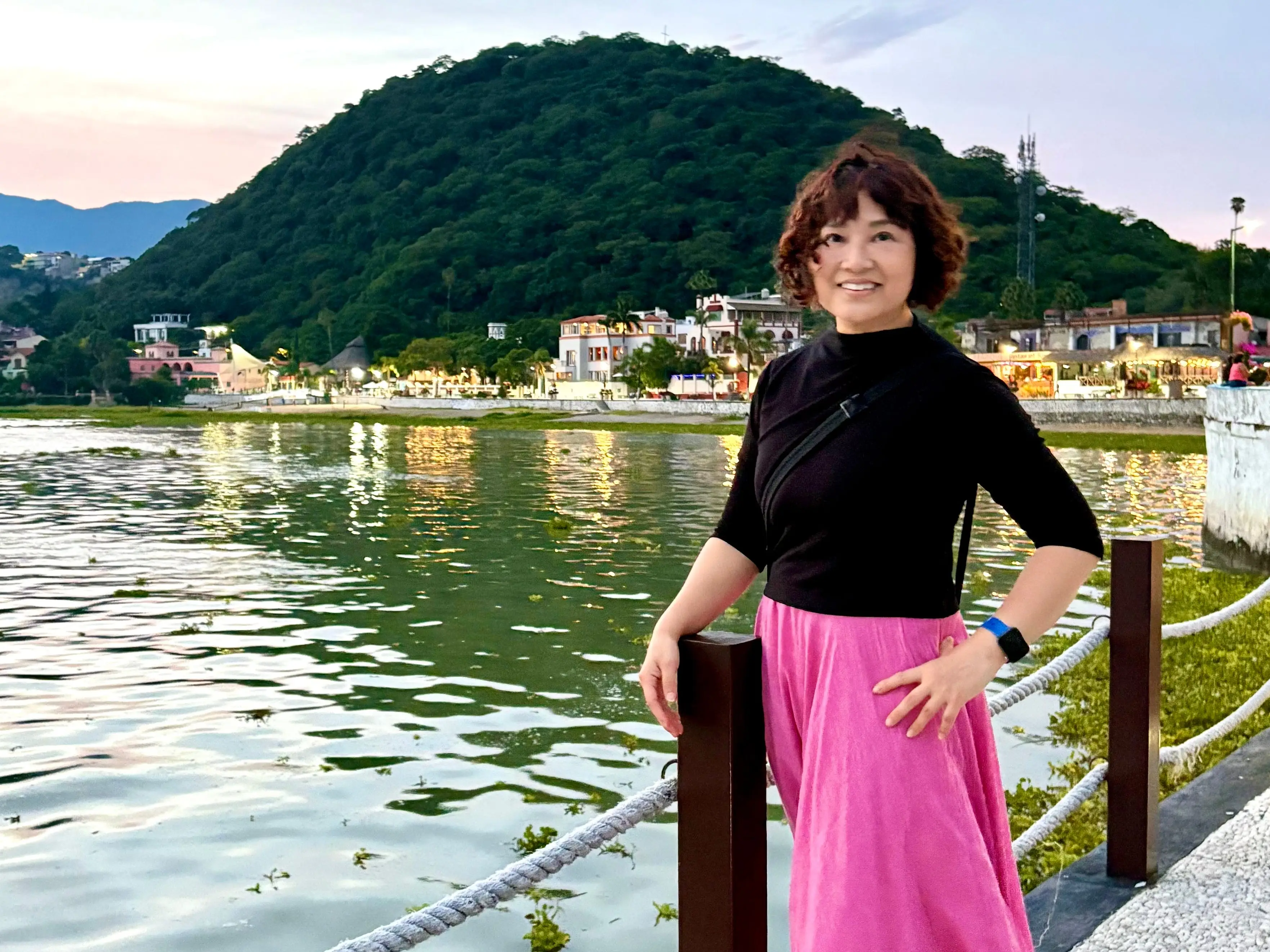 Author IVy Ge smiling in Mexico next to water