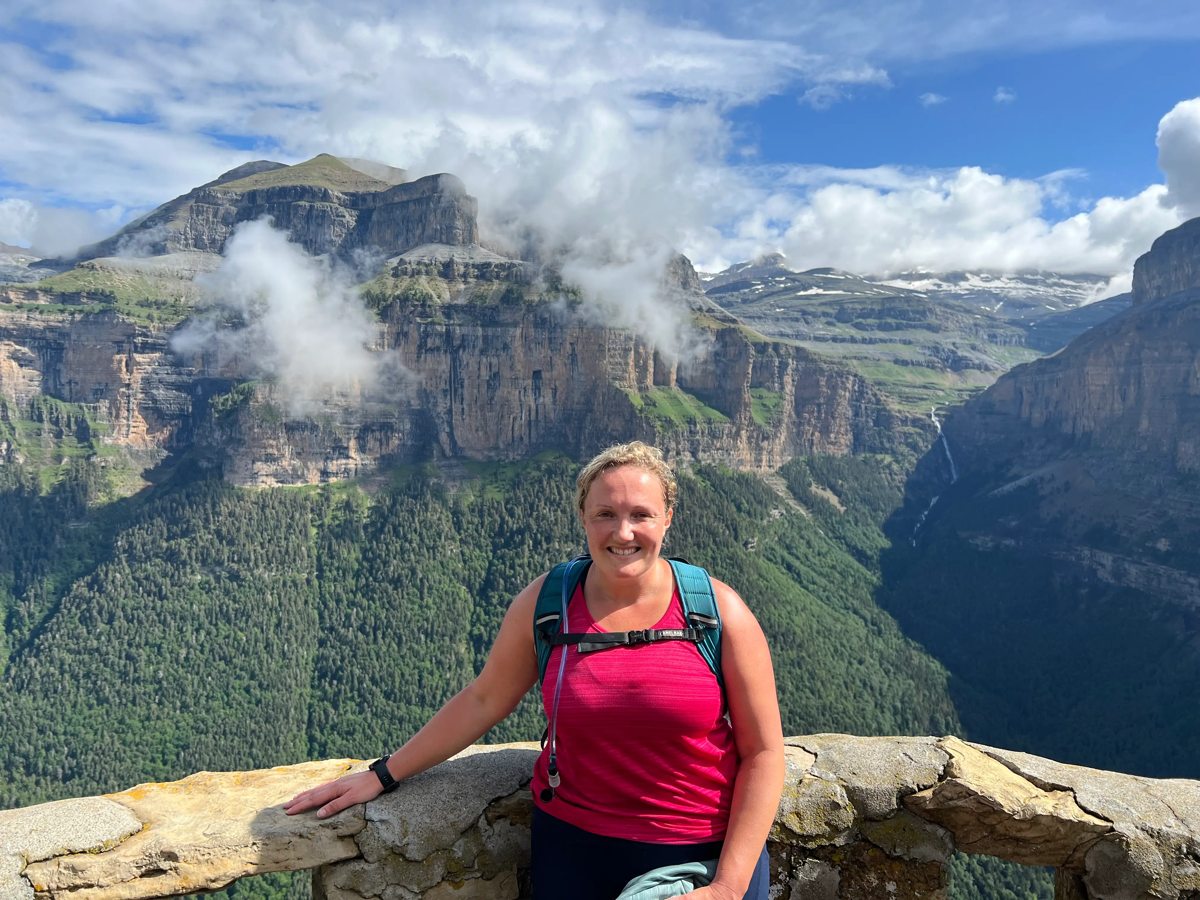 The author poses at a vista while traveling.