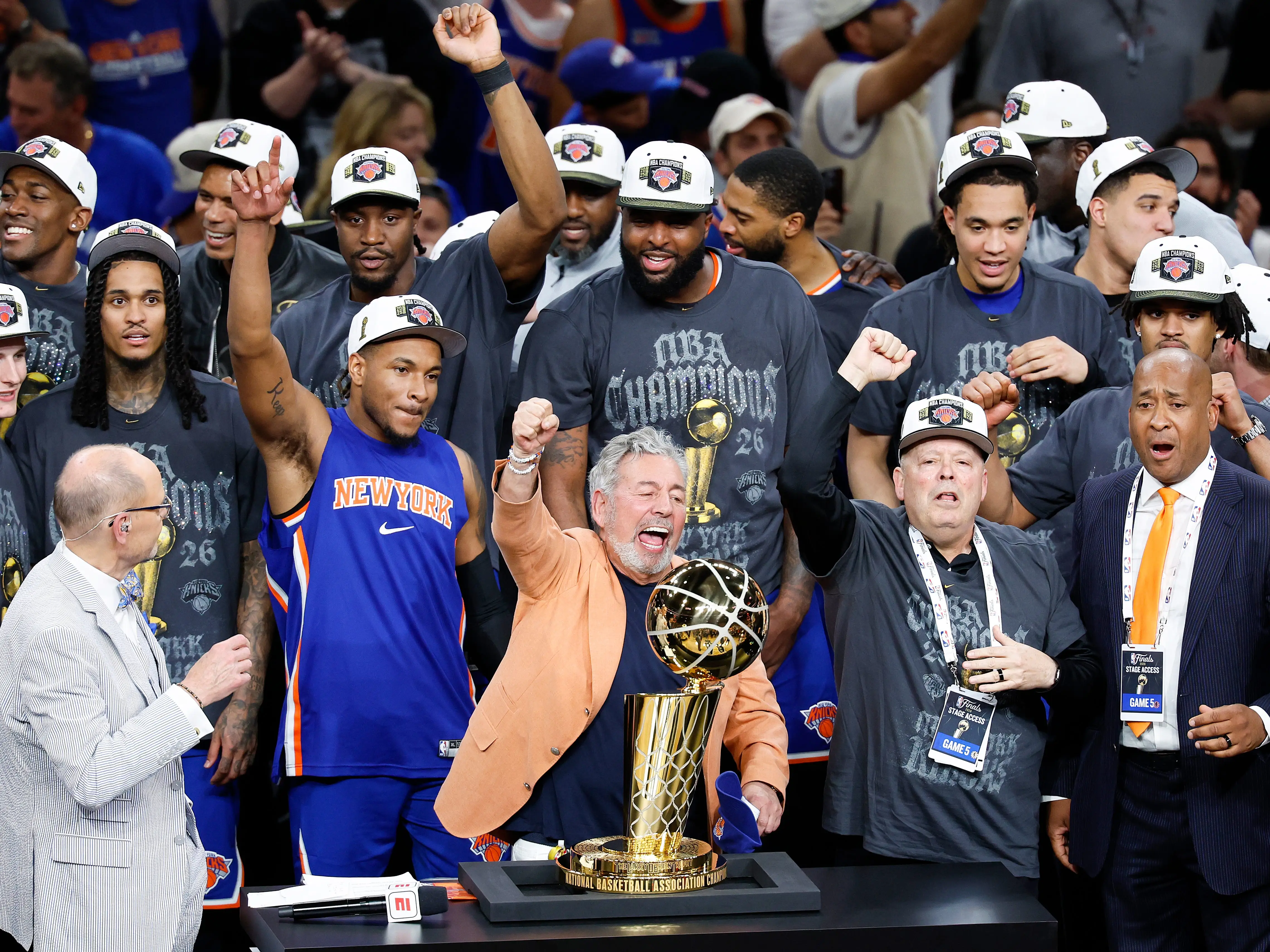 New York Knicks owner James Dolan and president Leon Rose celebrate the team's NBA championship win with the players.