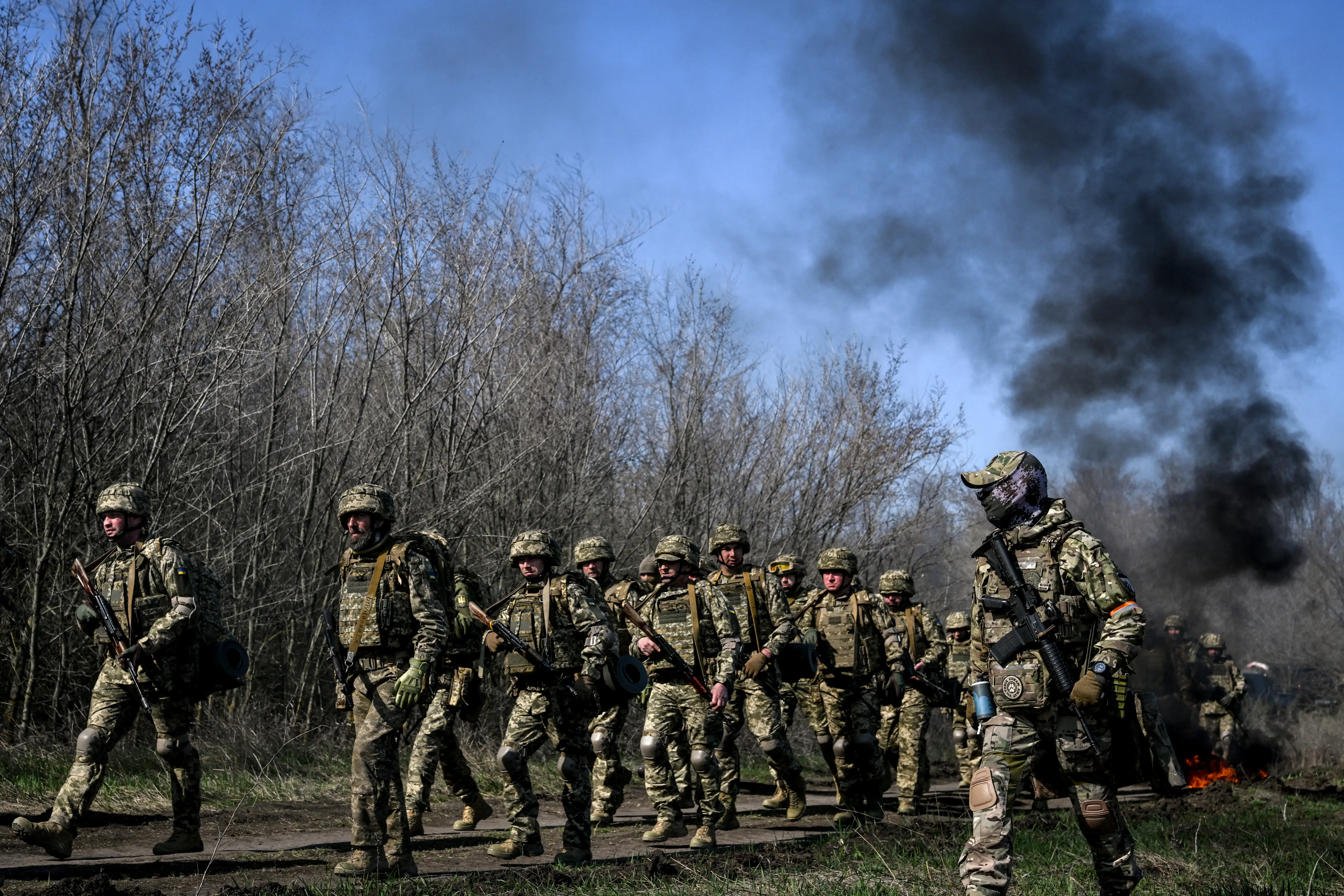 Ukrainian troops march with their instructors.